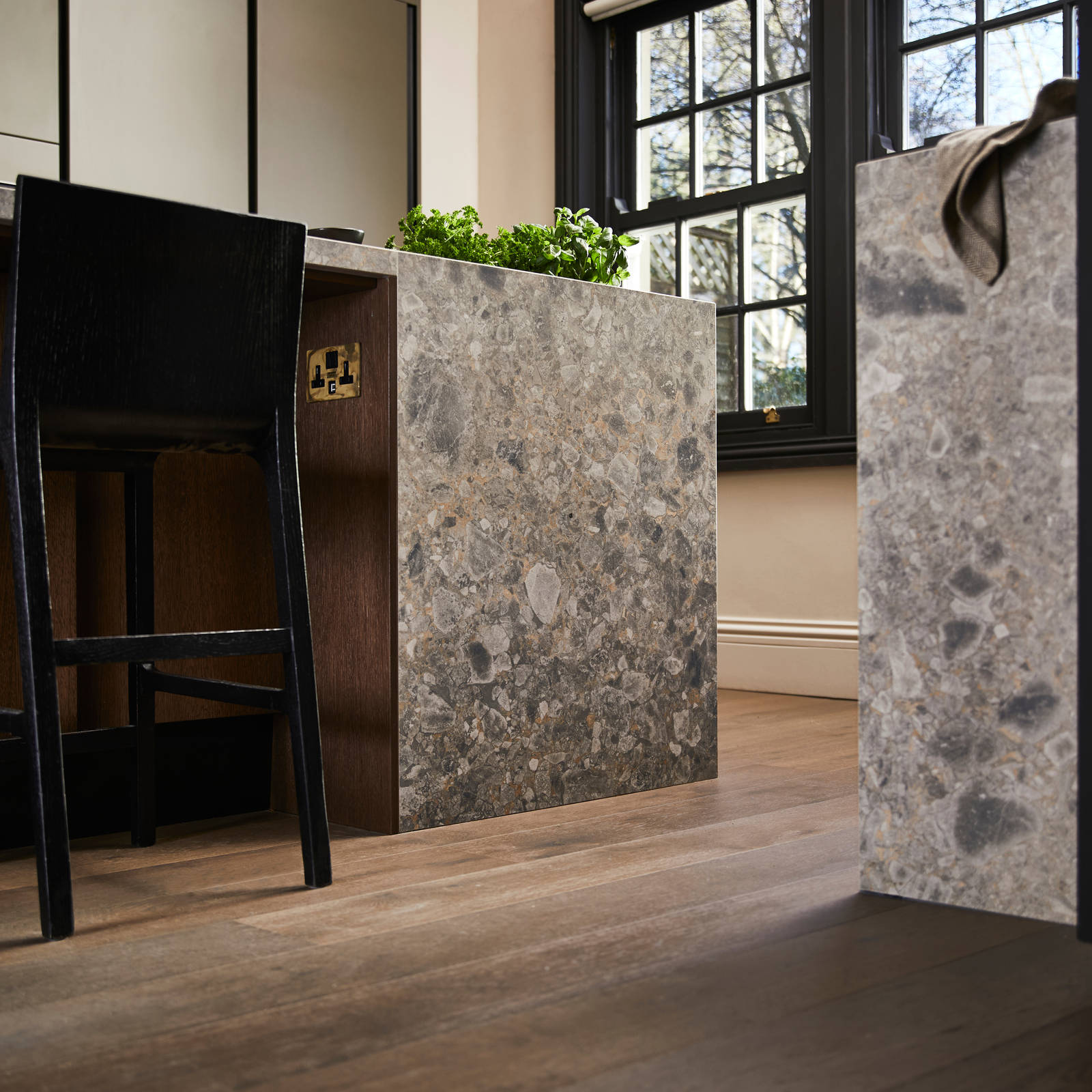 Floor level view of kitchen island seating area with a black tall chair