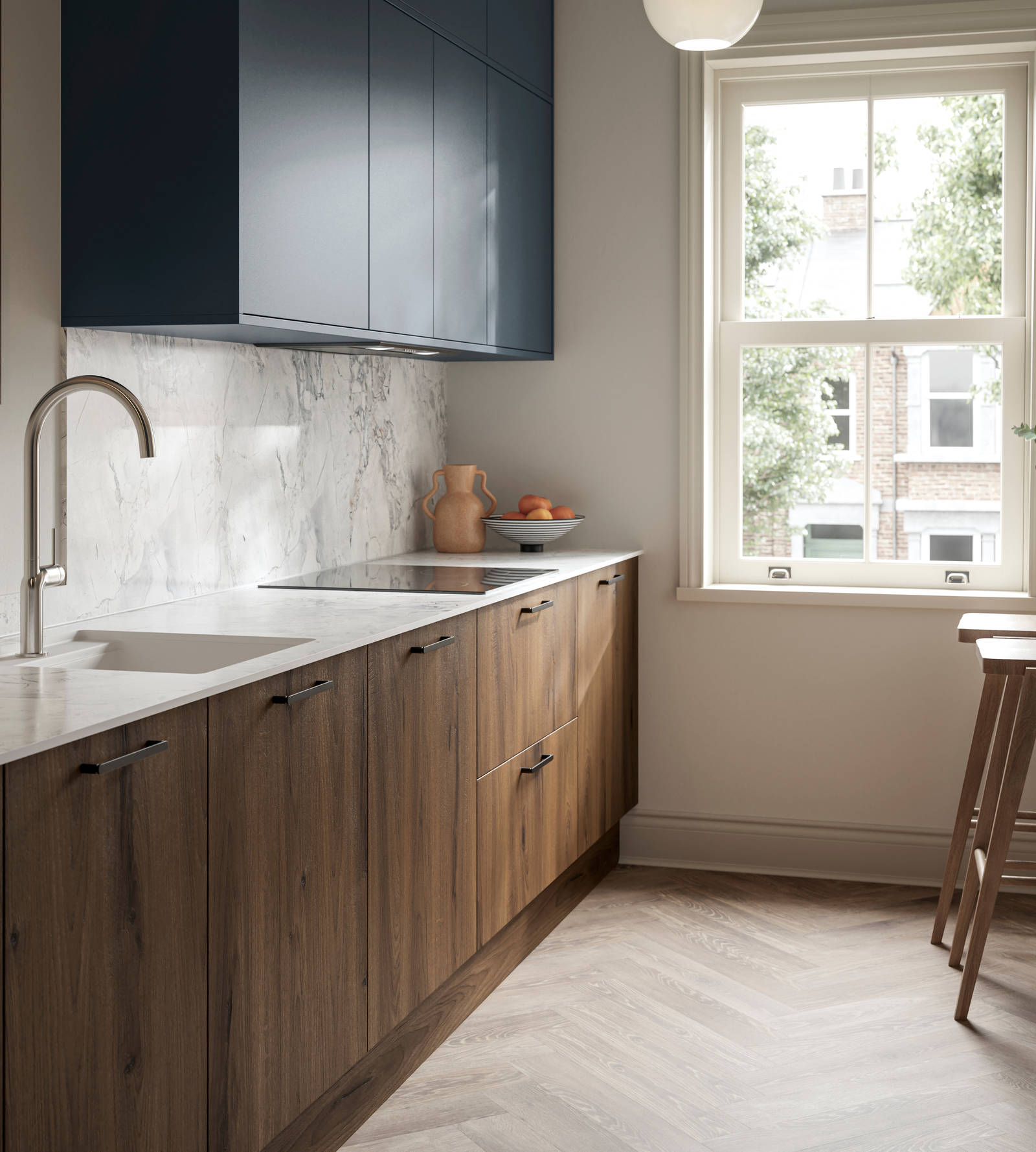 Contemporary Ascoli Mineral Blue wall cabinets over Portobello Umbra kitchen cabinets with marbled compact laminate worktop, black handles, a breakfast bar with wood bar stools, and Amtico smouldered oak herringbone flooring.