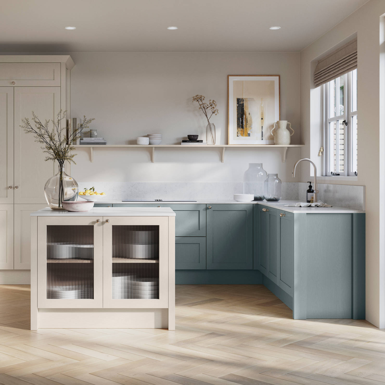 Open floorplan kitchen with small kitchen island in Wardley kitchen from Magnet in the light shade Limestone as well as blue Duck egg, decorated with flowers in glass vases and earth toned ceramics.