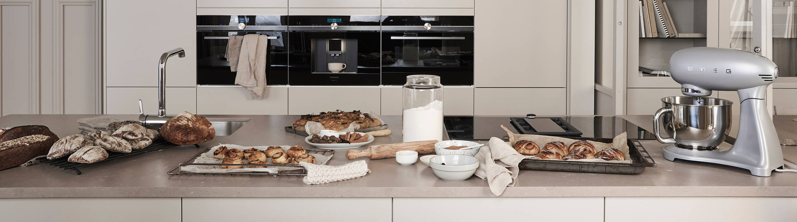 Marbodal Arkitekt plus Sand - kök i beige kulör med köksö. handtagslöst med Tip-on, bänkskiva i kvartskomposit Beach Clay.