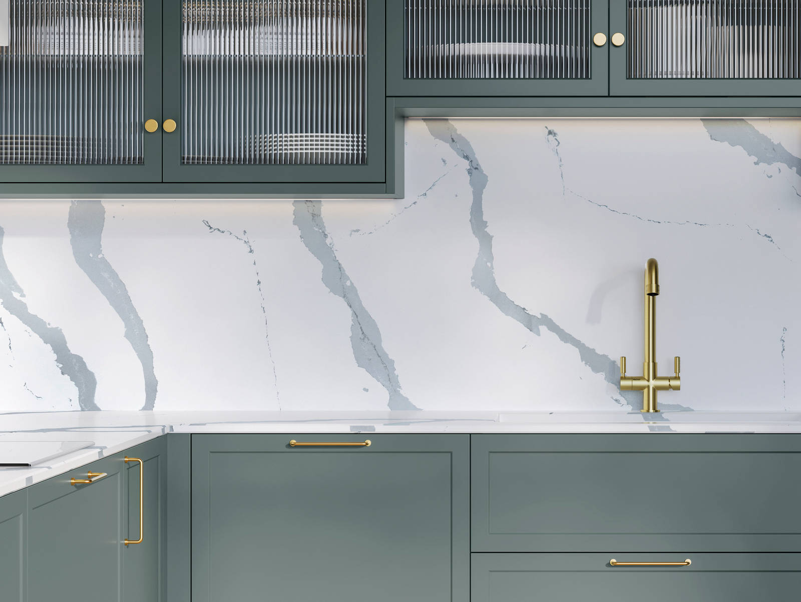 Modern Shaker kitchen Brunswick Spruce, a muted green shade, wall cabinets with fluted glass doors, Quartz Bianco Calacatta worktop and splashback, brass accessories like knobs, handles and tap, and a light wood herringbone floor.