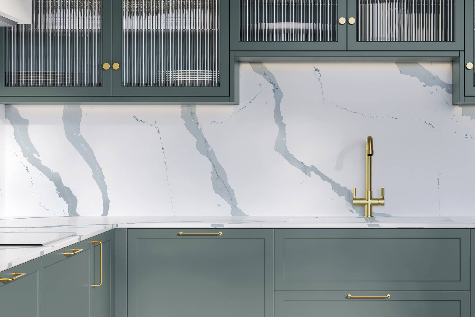 Modern Shaker kitchen Brunswick Spruce, a muted green shade, wall cabinets with fluted glass doors, Quartz Bianco Calacatta worktop and splashback, brass accessories like knobs, handles and tap, and a light wood herringbone floor.