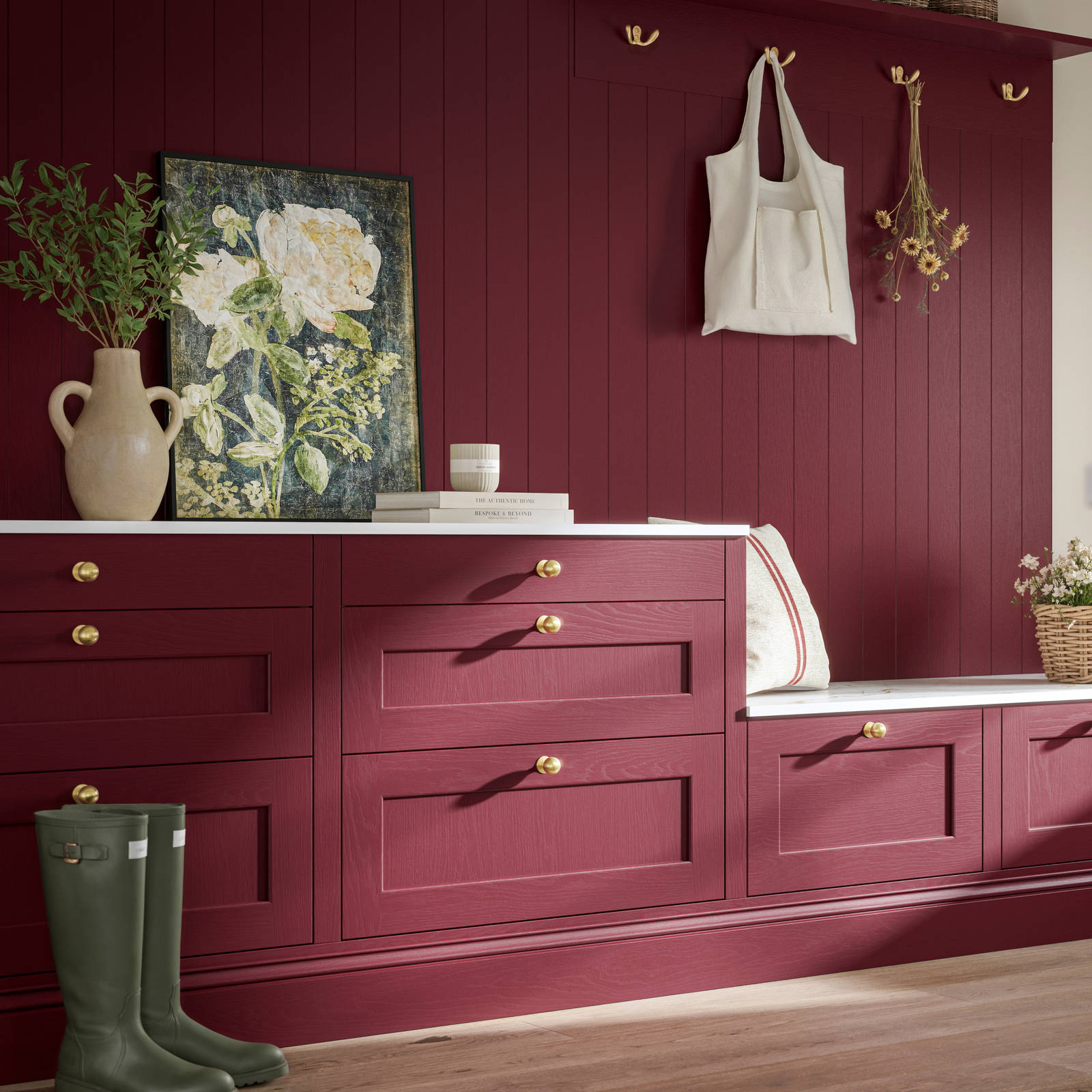 Traditional Shaker-style tactile woodgrain Ludlow kitchen bootroom space in bold shade Morello, brass accents and dusty oak vinyl flooring with Ludlow parchment kitchen island in foreground.