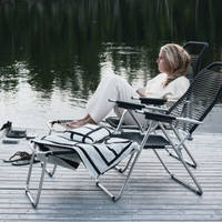 Lotta Agaton i en stol på bryggan vid Piteälven intill landstället