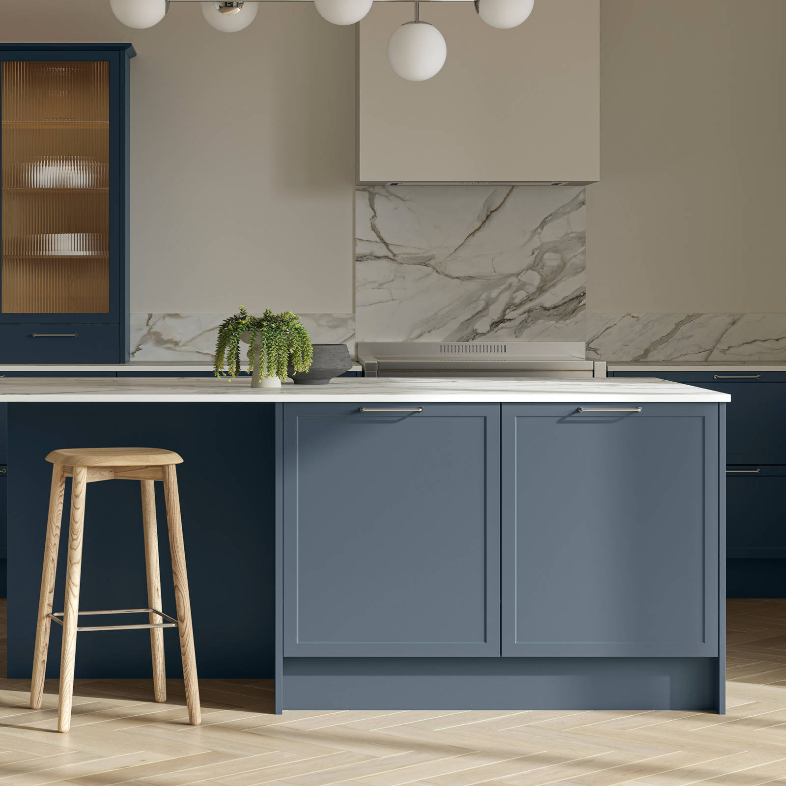 Modern Shaker kitchen Brunswick Voyage blue and Limestone with white and grey marbled worktop and matching splashback, a kitchen island with light wood stools at breakfast bar and vitrine cabinets with fluted glass, light wood herringbone flooring.