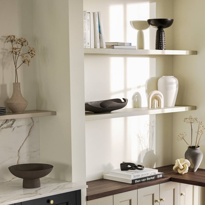 View over kitchen island in Traditional Shaker-style tactile woodgrain Ludlow Sumi Black kitchen, brass details, and dark wood worktop in home office with Ludlow French clay seating area by black metal frame full height window.
