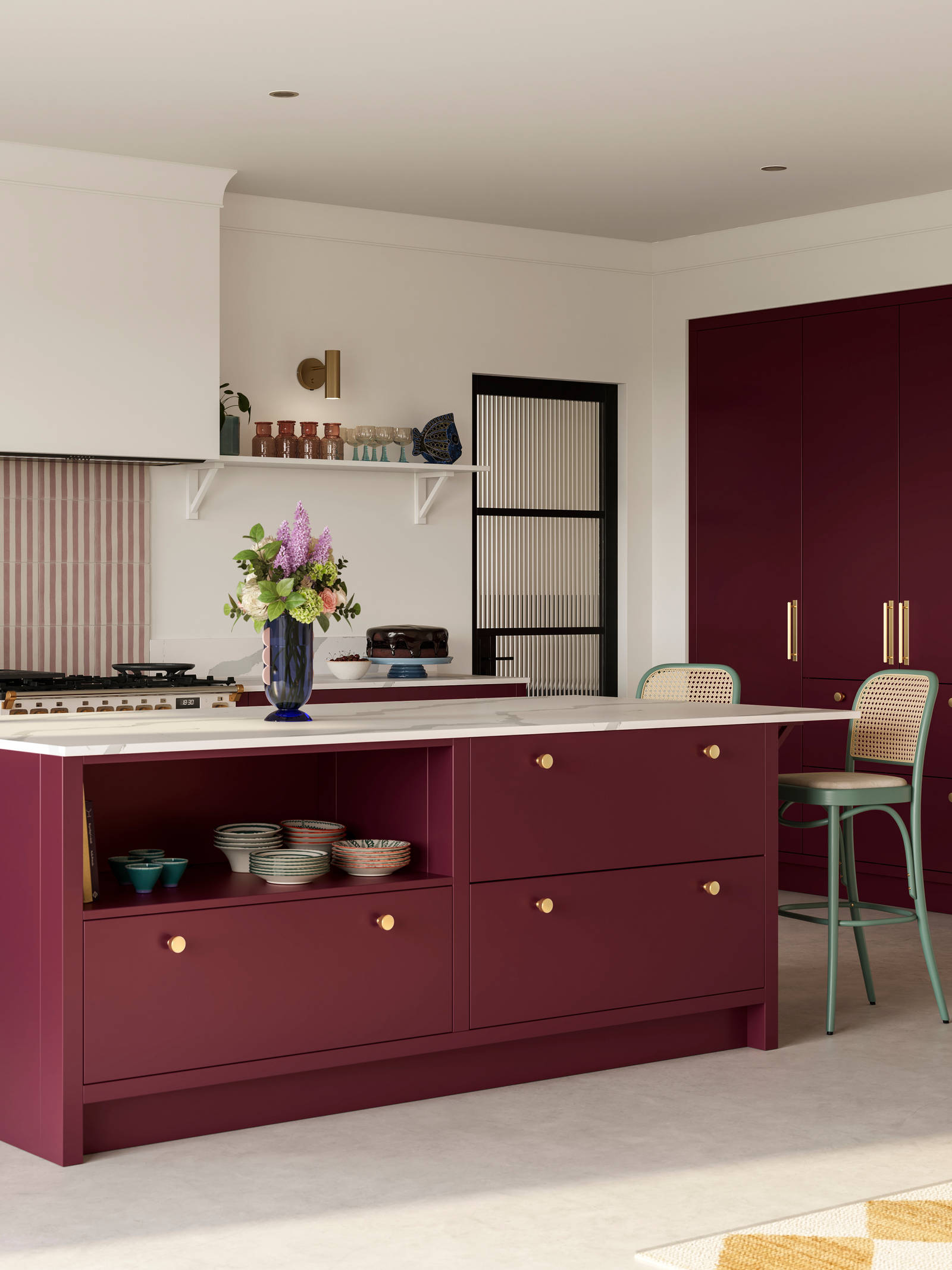Modern slab front Soho Morello kitchen with built-in tall cabinets hiding integrated refrigerator, kitchen island with rattan bar stools at breakfast bar, Bianco calacatta worktop and upstand, brass knobs and open shelf in kitchen island holding eclectic eramics.
