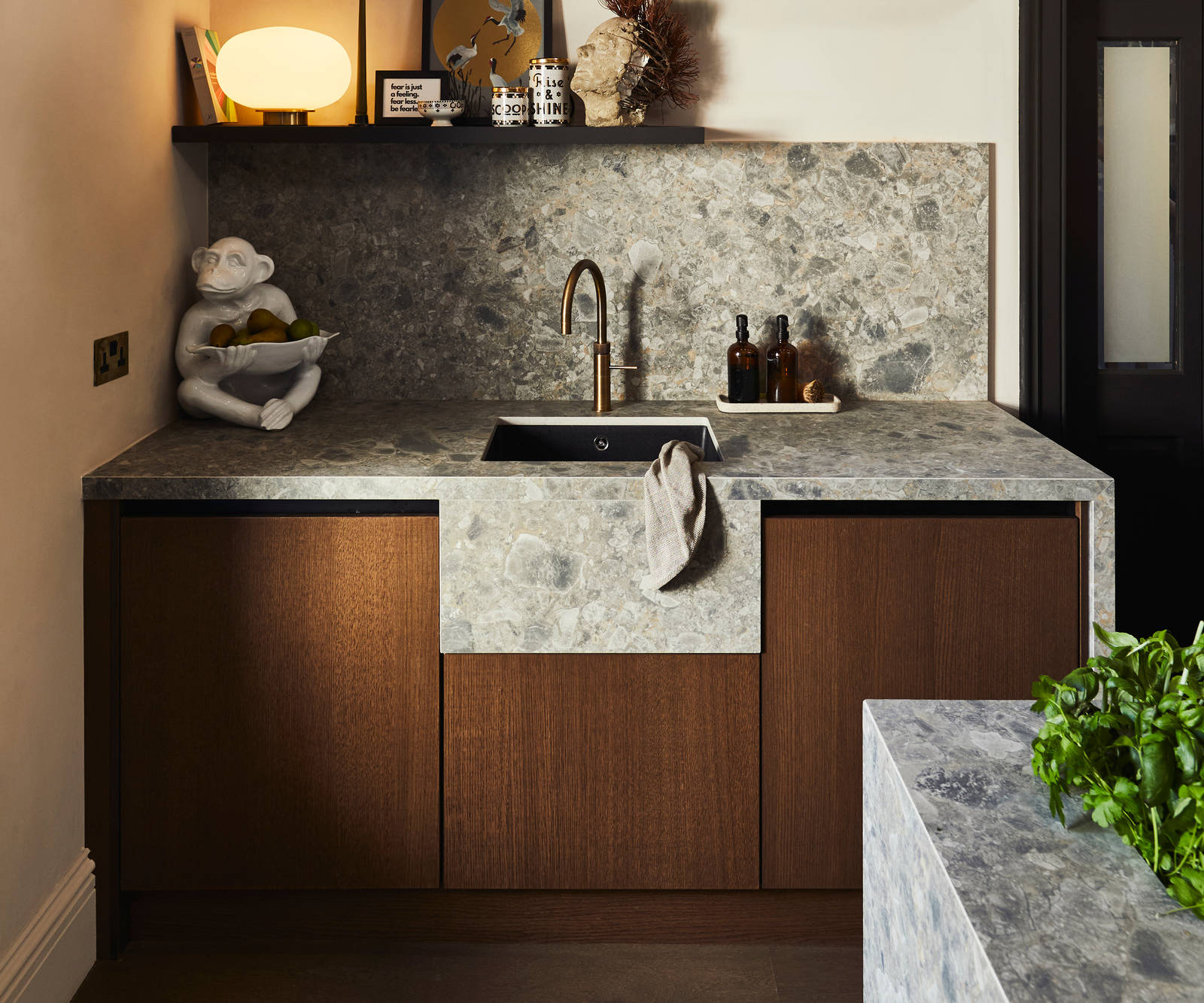 Sink area with Dekton in Ceppo backsplash and worktop, Nordic Nature cabinetry and a brass Quooker tap.