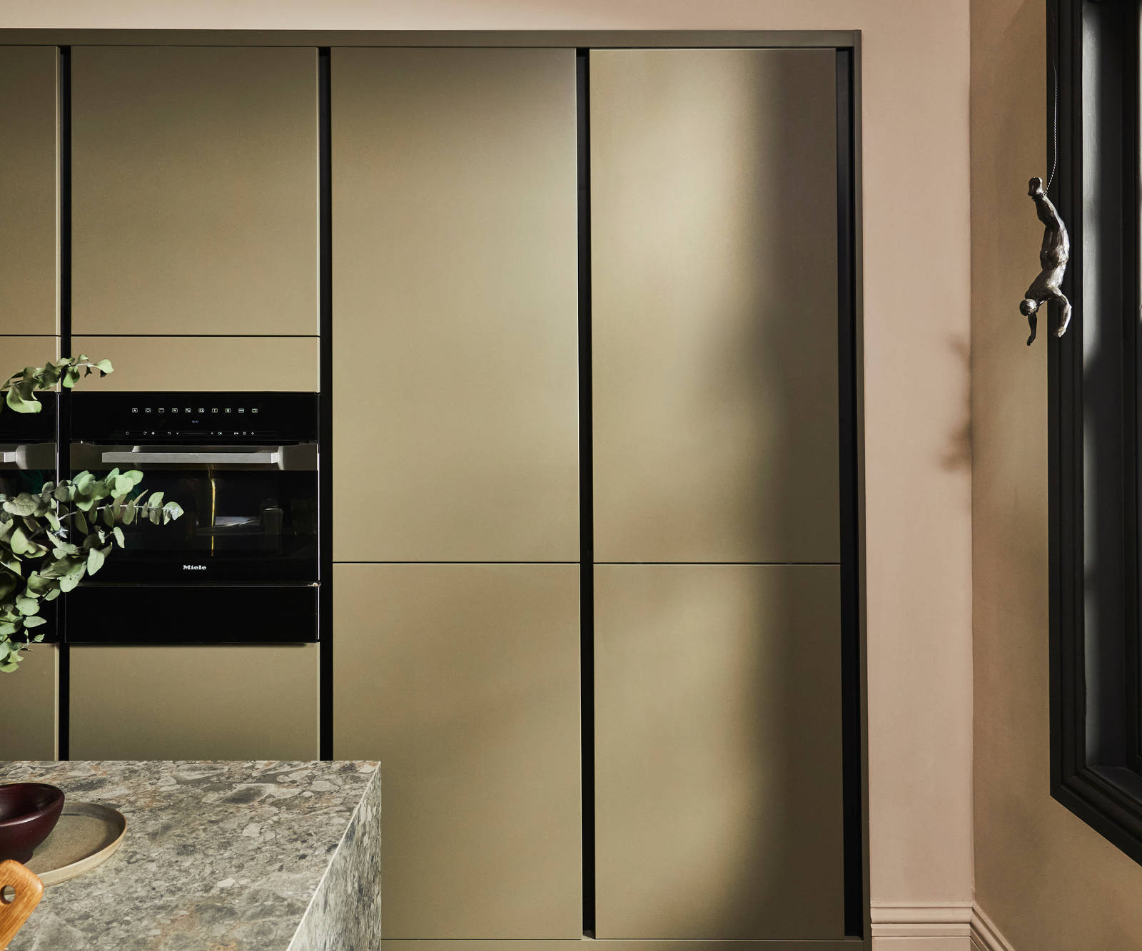 Tall modern slab Soho Balmoral cabinets, containing integrated refrigerators.