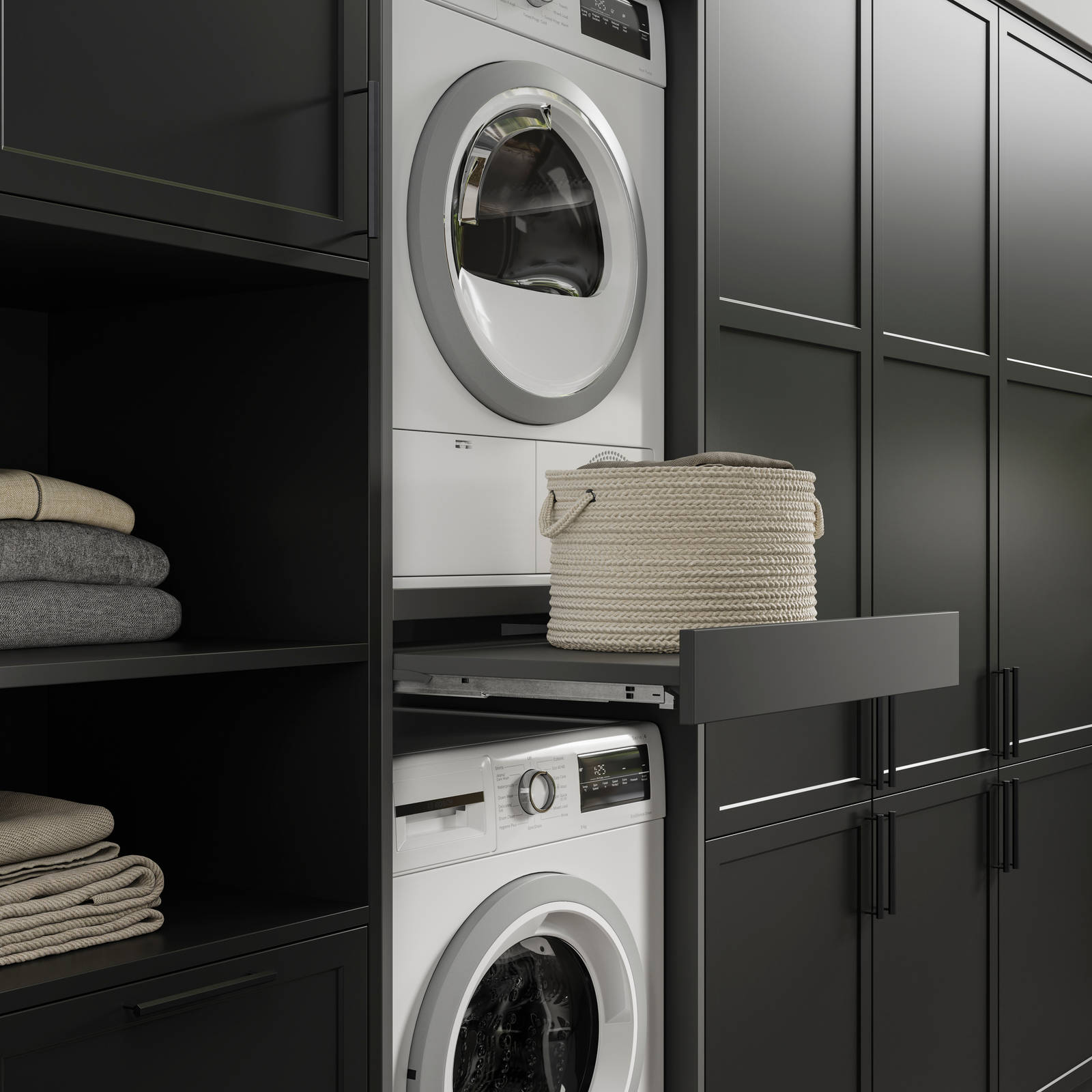 Pulled out drawer between laundry machine and dryer to serve as a shelf in black modern shaker Brunswick kitchen and laundry room