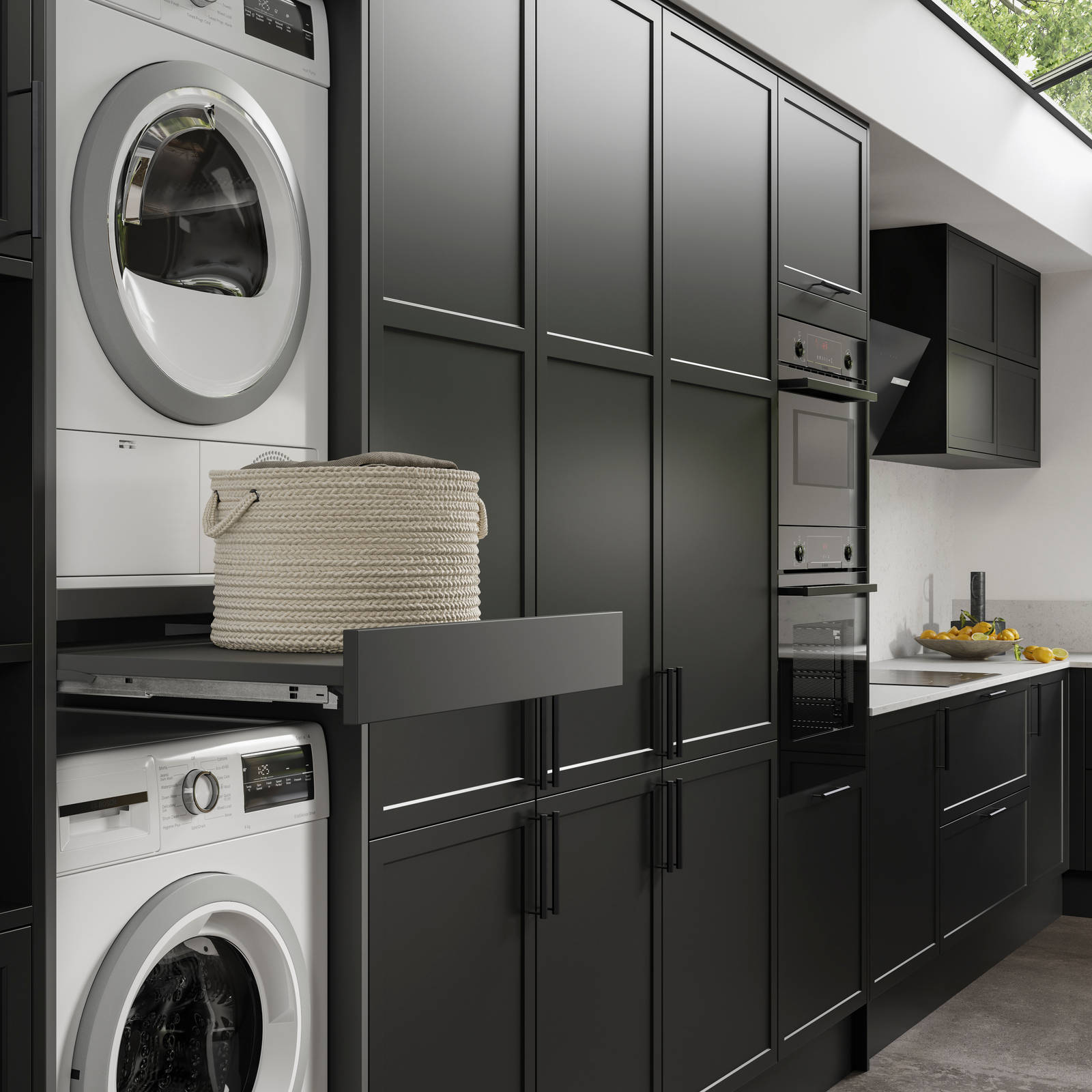 Pulled out drawer between laundry machine and dryer to serve as a shelf in black modern shaker Brunswick kitchen and laundry room