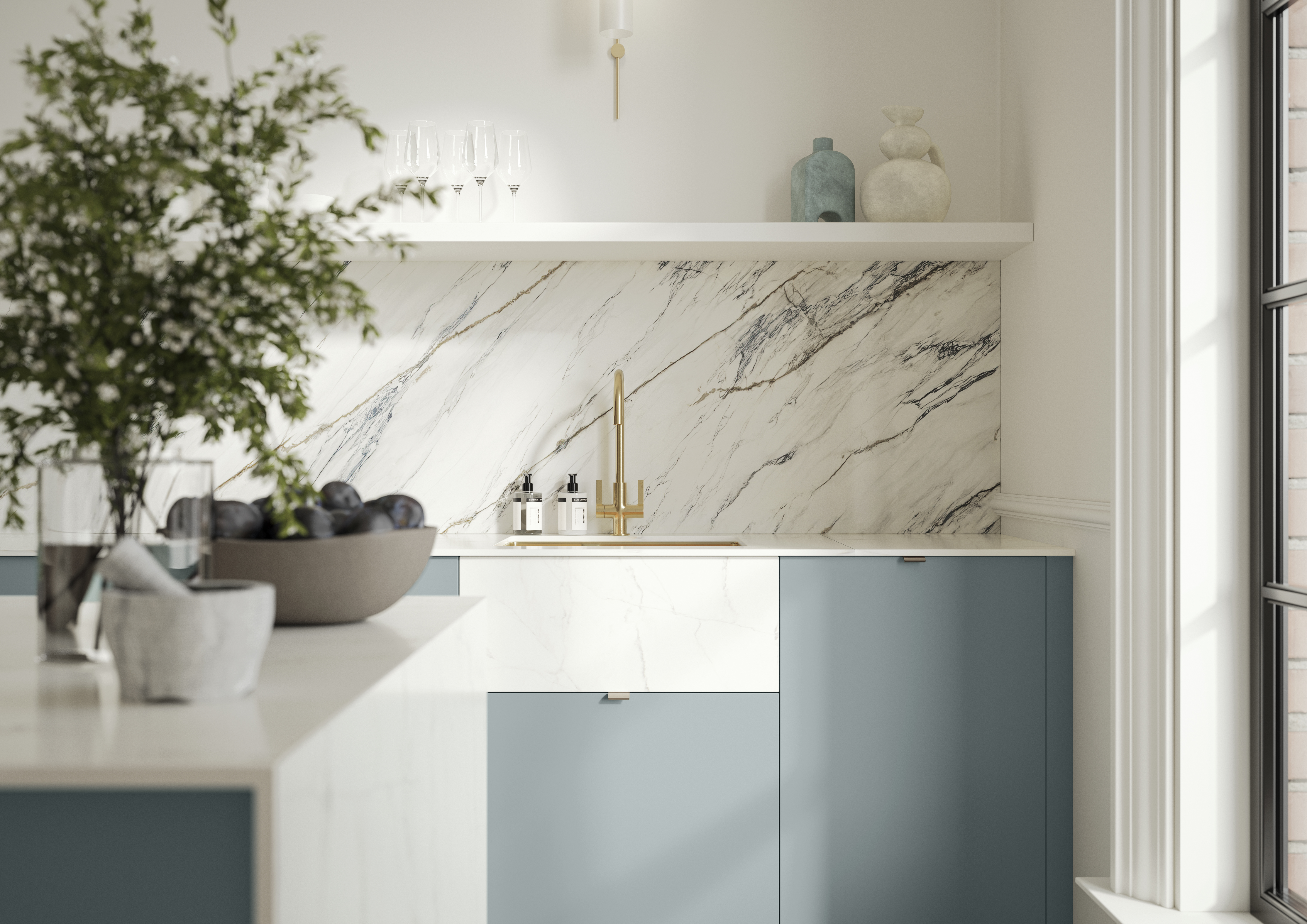 Soho Duck Blue kitchen from Magnet with white marble splashblack, paired beautifully with a bright brass tap and sink.