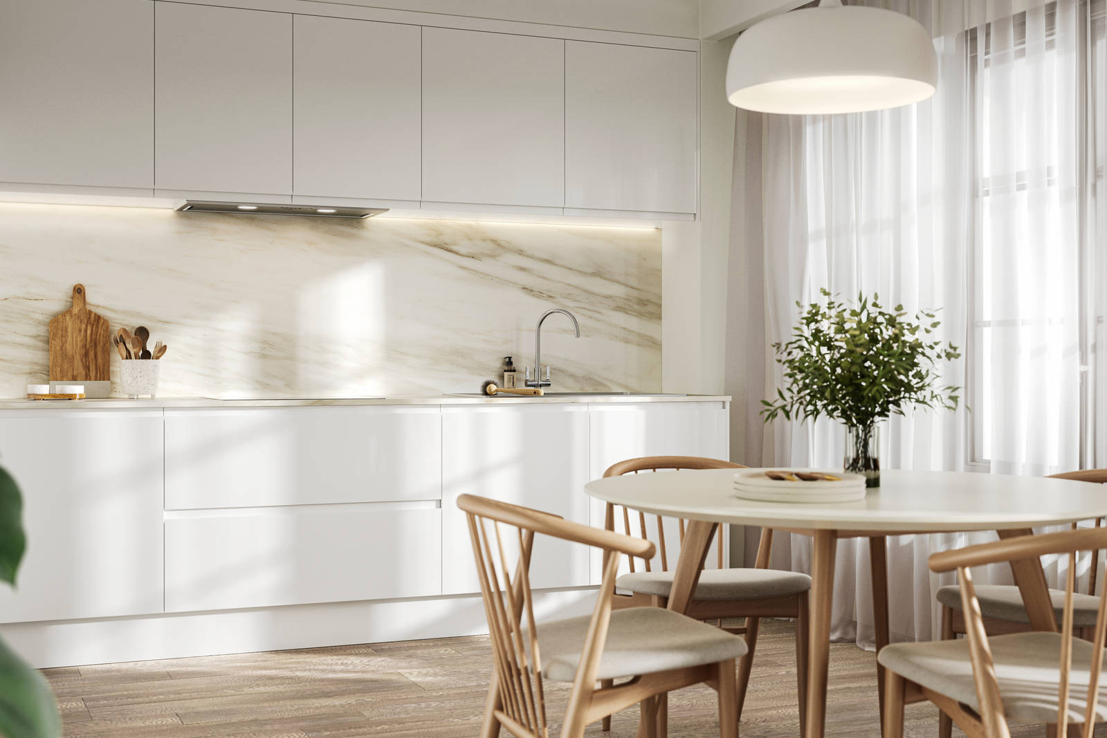 Handleless white gloss Luna kitchen from Magnet, a round wooden kitchen table with matching chairs in foreground
