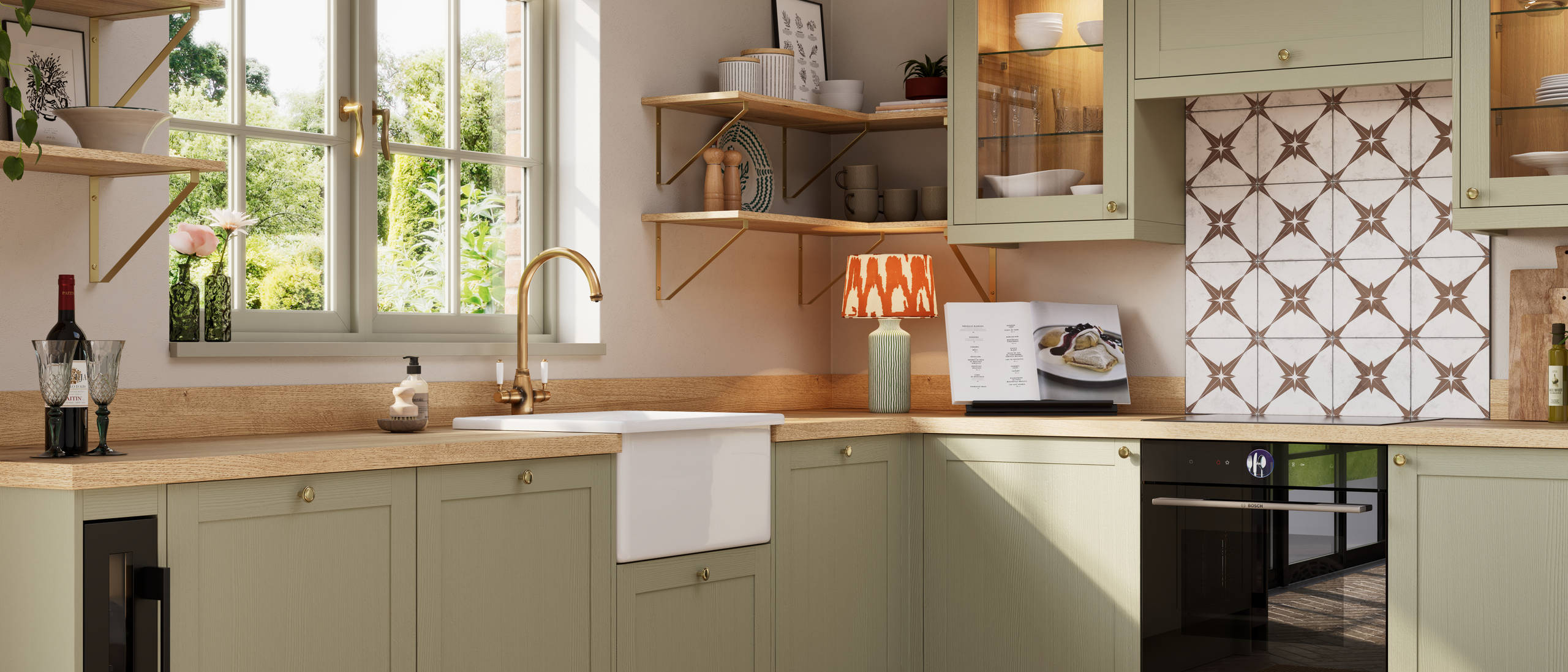 Close-up view of contemporary Shaker kitchen Ambleside from Magnet in sage green shade Meadow with belfast sink, aged taps and wooden effect worktop.