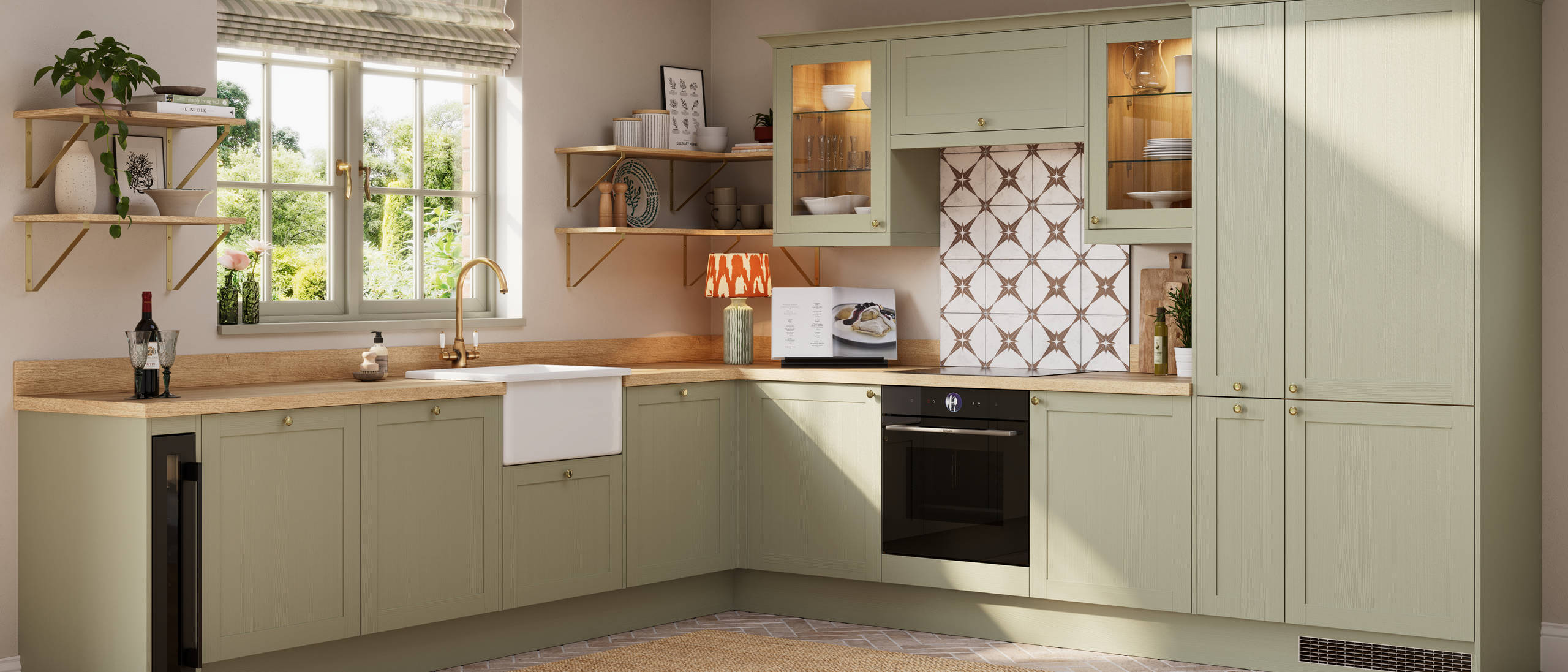 Contemporary Shaker kitchen Ambleside from Magnet in sage green shade Meadow with belfast sink, aged taps and wooden effect worktop.