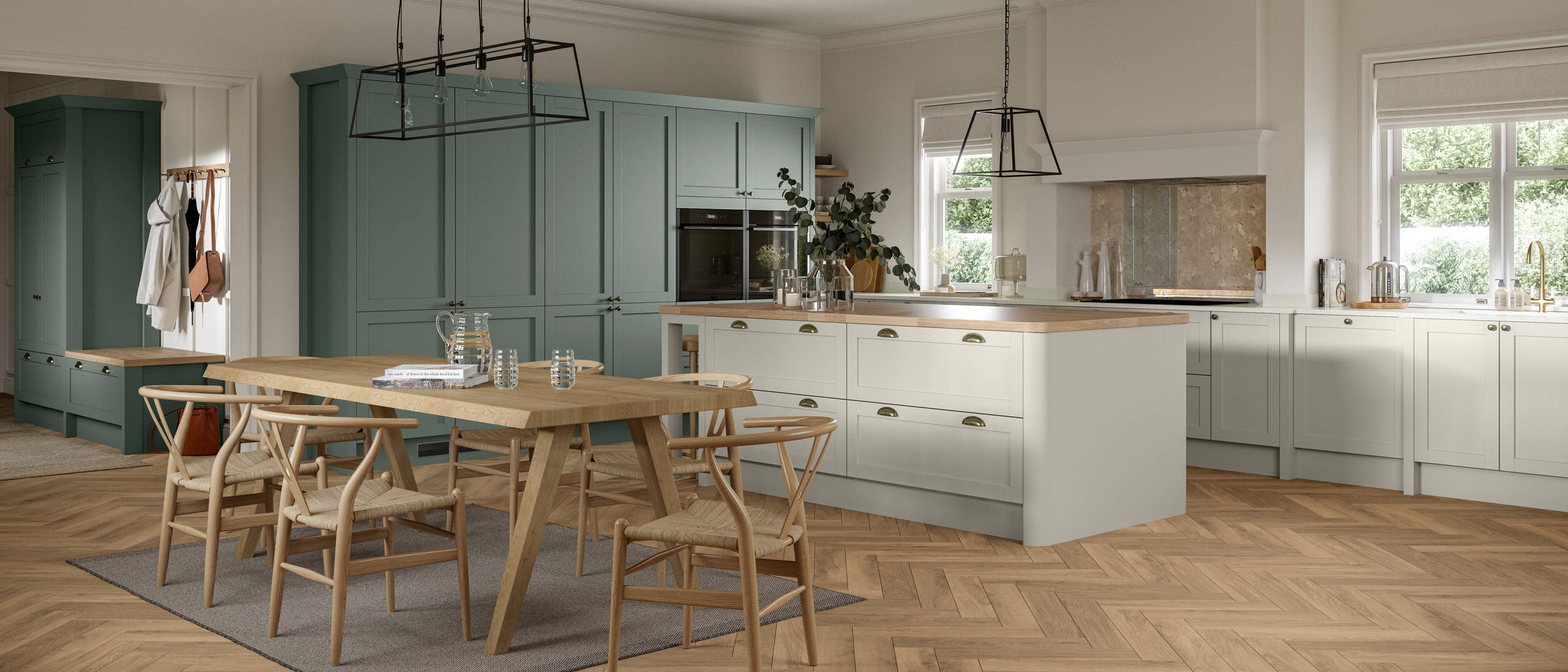 Ambleside Shaker kitchen in Moss and Limestone colours, featuring cup handles, and a spacious open-plan layout.