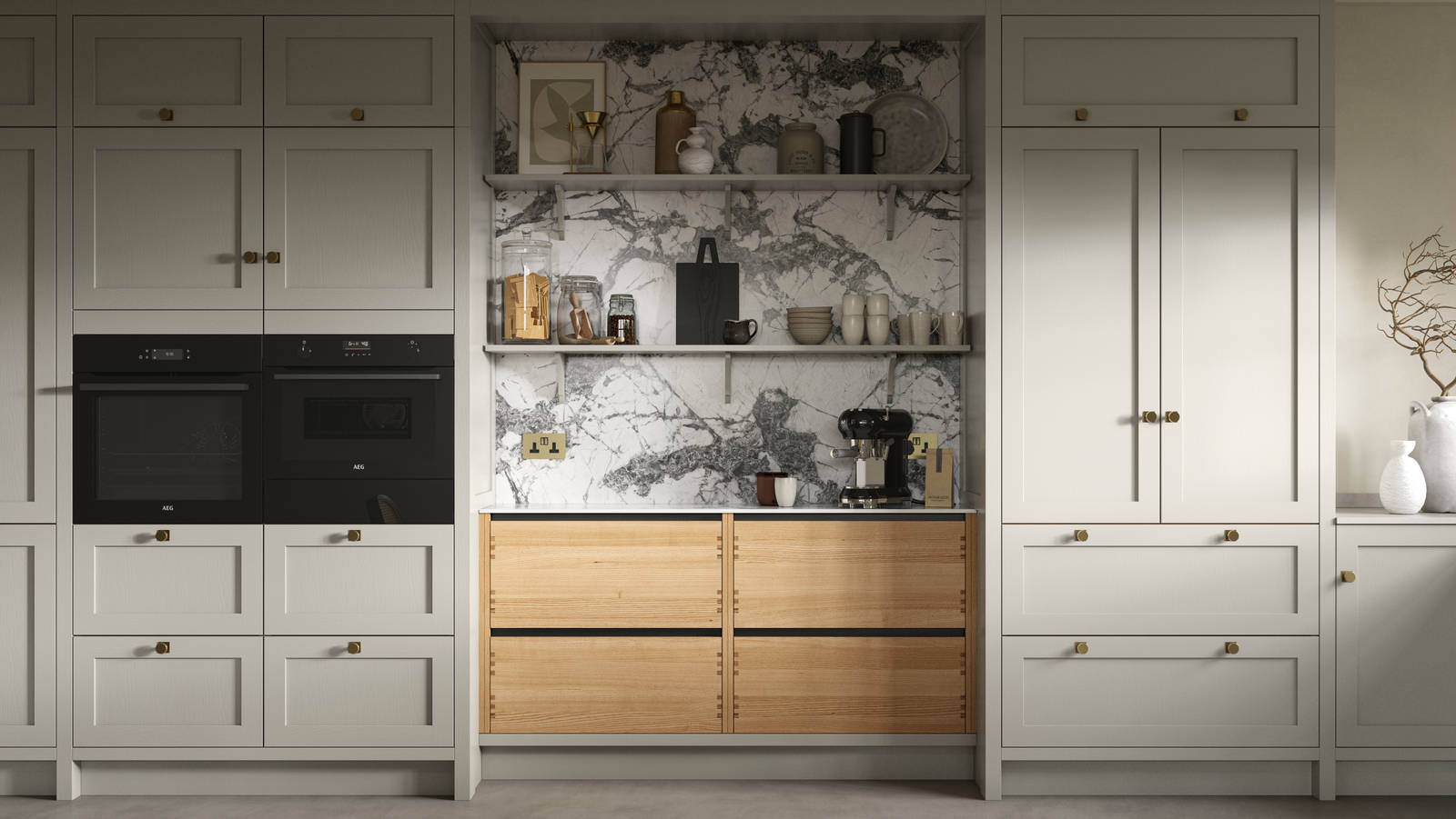 A neutral Shaker kitchen with Pebble and Nordic Craft cabinetry, marble splashback behind open shelves and paired with brass handles.