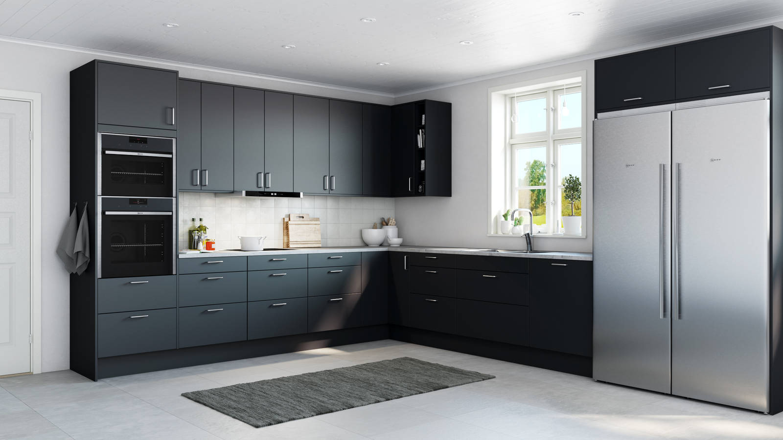 Tidlösa och stilrena Arkitekt Plus från Marbodal i den mörkblå kulören Hav, integrerade ugnar och kyl/frys i rostfritt stål.