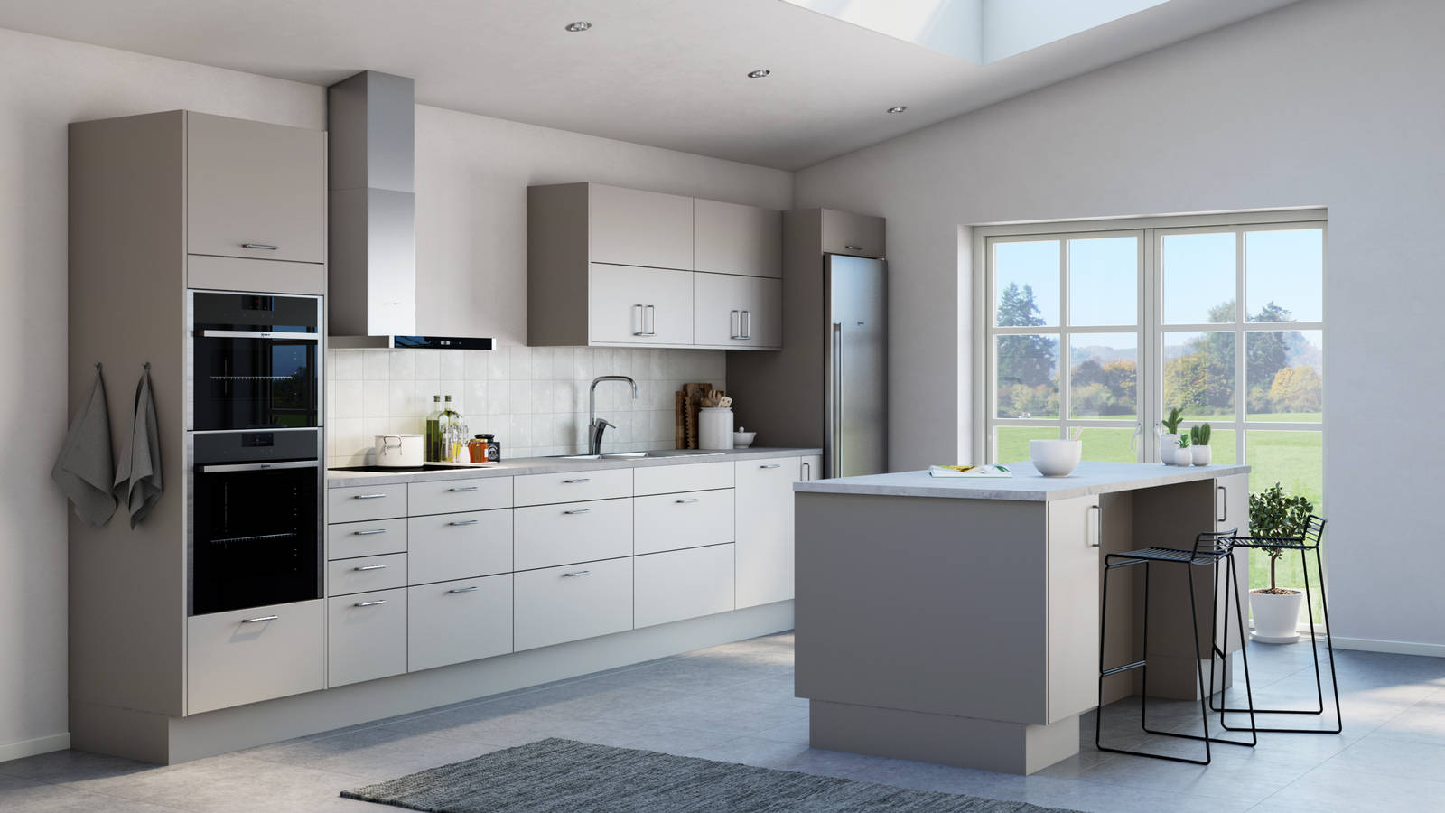 Tidlösa och stilrena Arkitekt Plus från Marbodal i greige kulör Frö, integrerade ugnar, kyl/frys i rostfritt stål och en köksö.