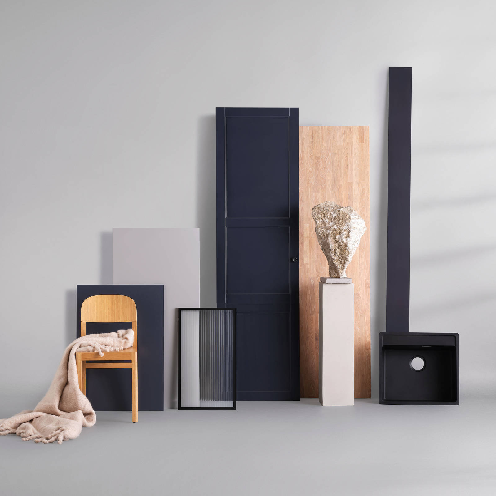 Blå kökslucka, vitrinlucka med räfflat glas, svart diskho, trästol, bänkskiva i massivträ