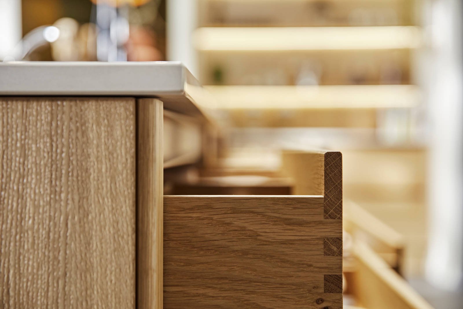 Close-up side view of opened oak drawer in Nordic Craft kitchen island.