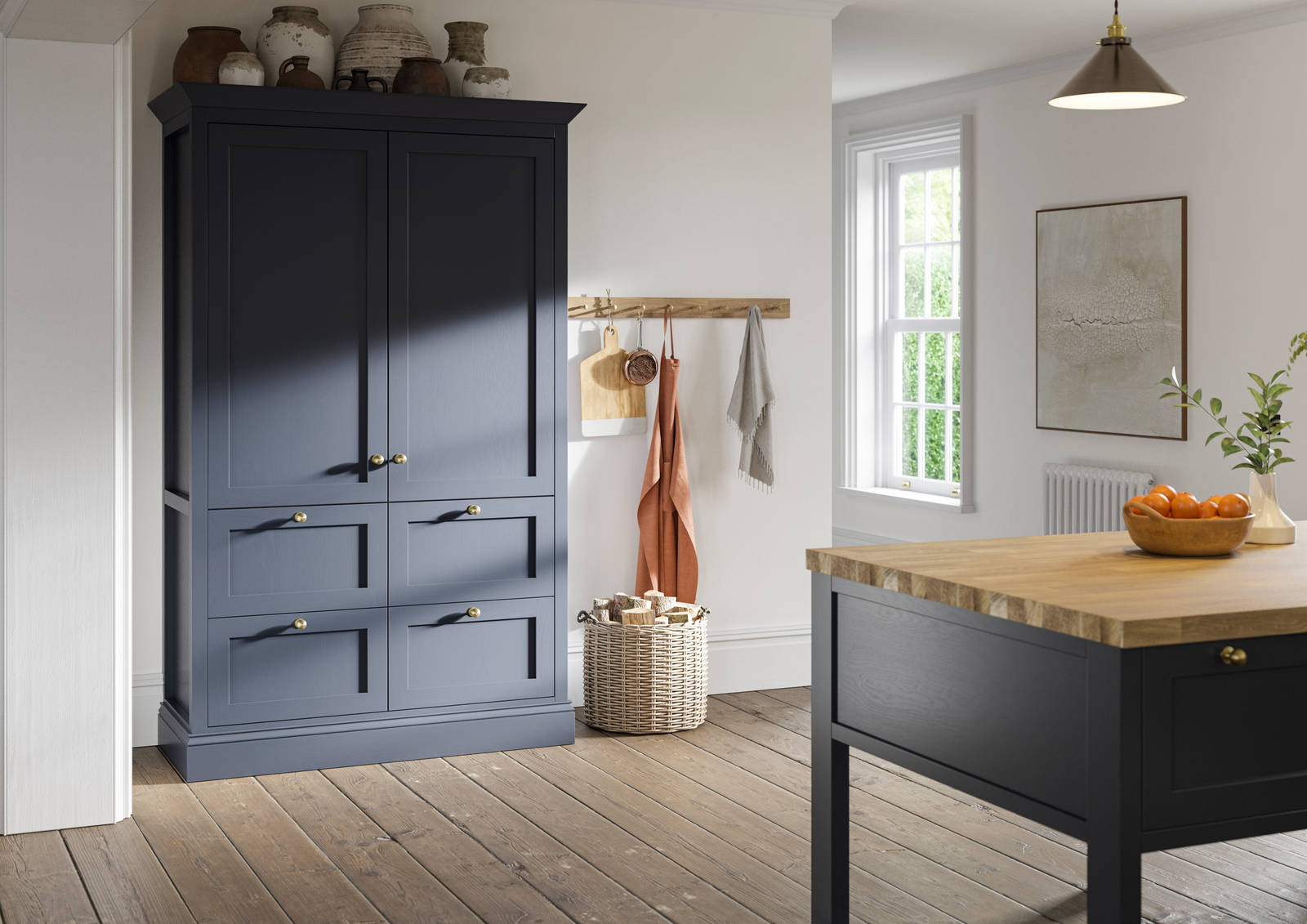 Tall shaker cabinet in dark blue shade, with handmade ceramics on top.