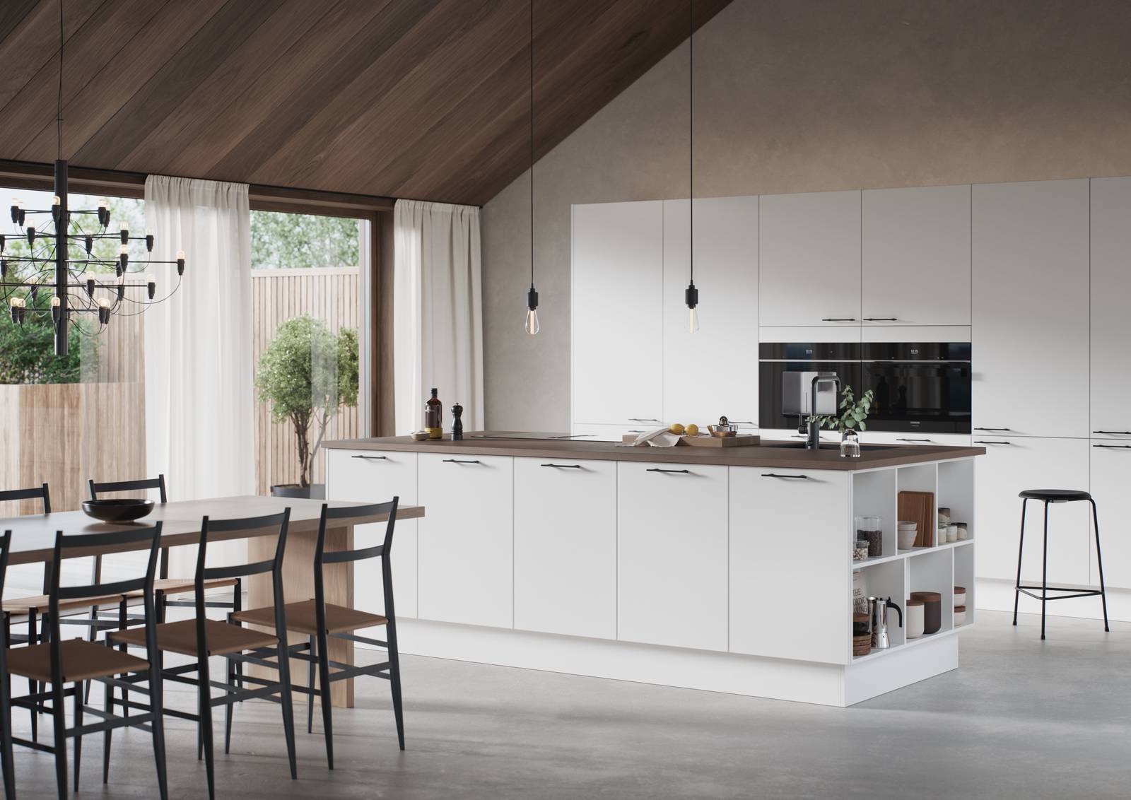 Hvit kjøkken og kjøkkenøy med slank og elegant front med svakt avrundede kanter, Corestoen varm sement benkeplate, sort vask og sort kran, håndtak i sort støpejern.