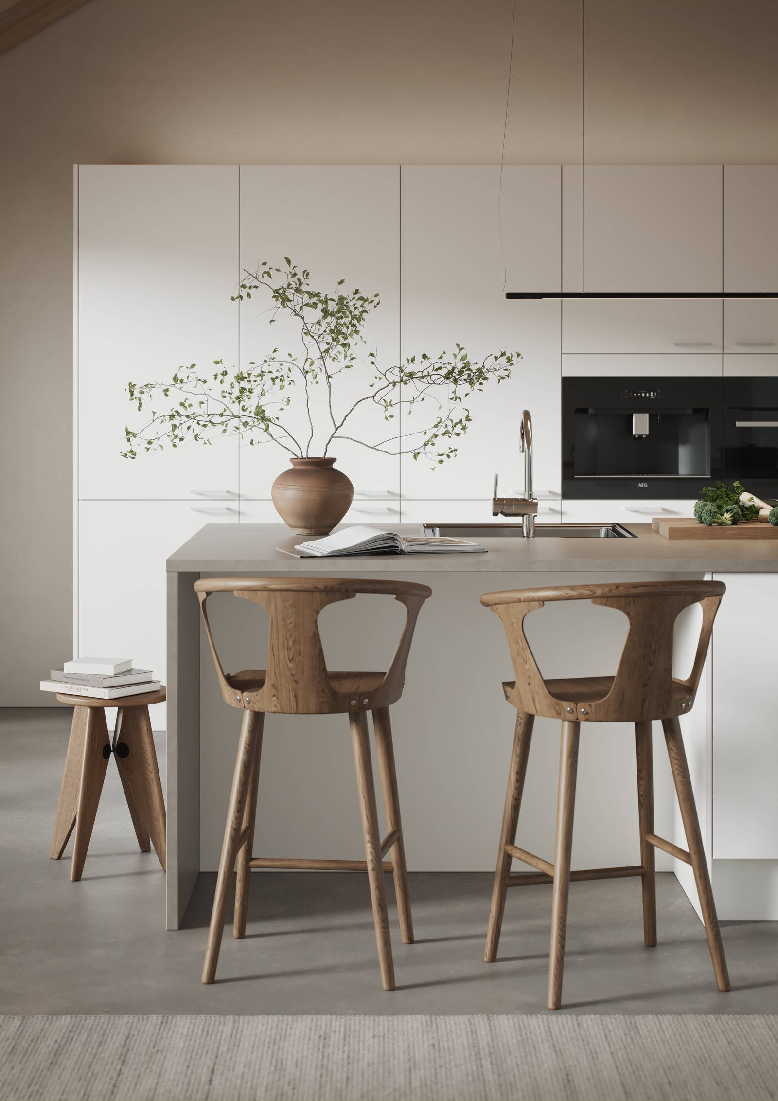 Hvit kjøkken med slank og elegant front med svakt avrundede kanter, kjøkkenøy med barstoler i tre