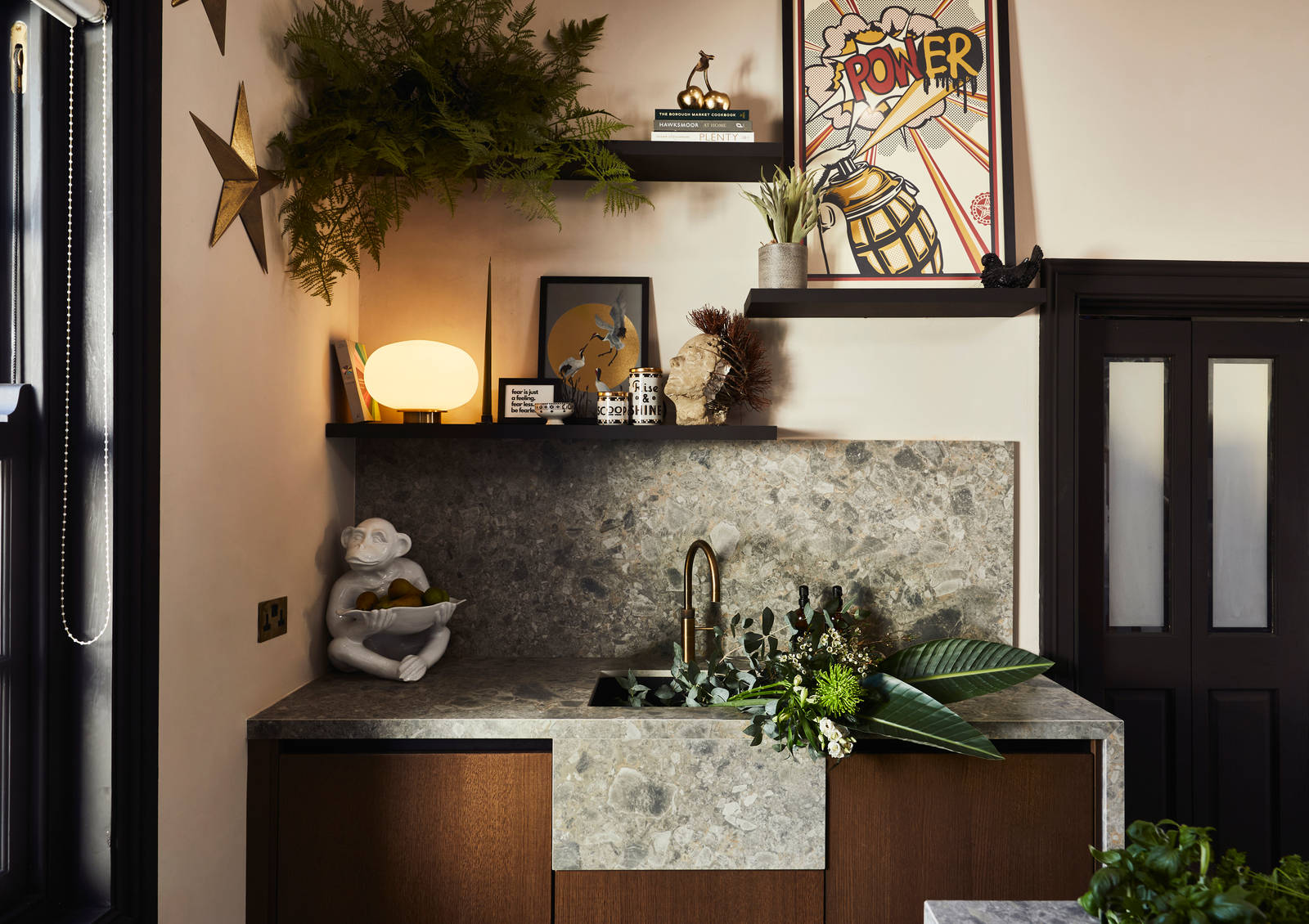 Fresh flowers in the sink area with Dekton in Ceppo backsplash and worktop, Nordic Nature cabinetry and a brass Quooker tap.