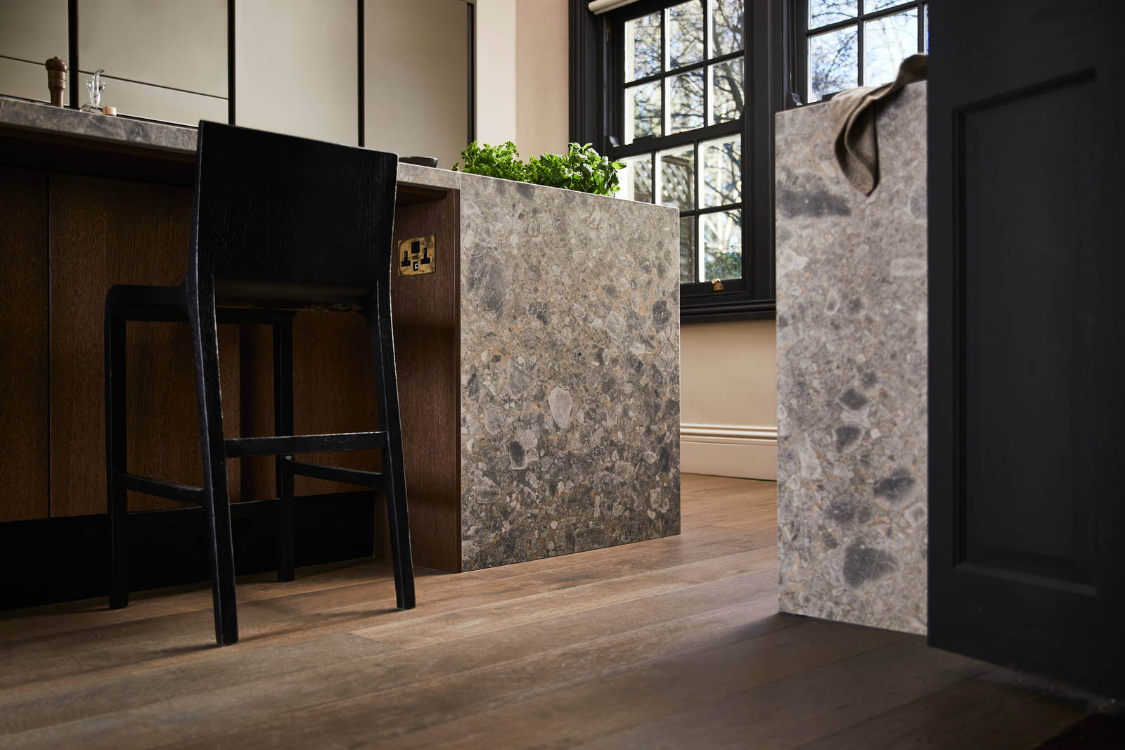 Floor level view of kitchen island seating area with a black tall chair