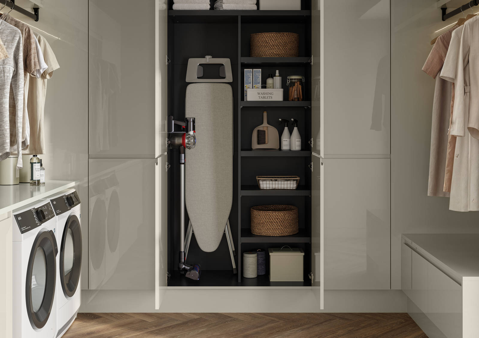 Luna Gloss Limestone utility room with tall cabinets, opened cabinets showing storage of Ironing board and laundry detergents, Amtico smouldered oak in parquet flooring.