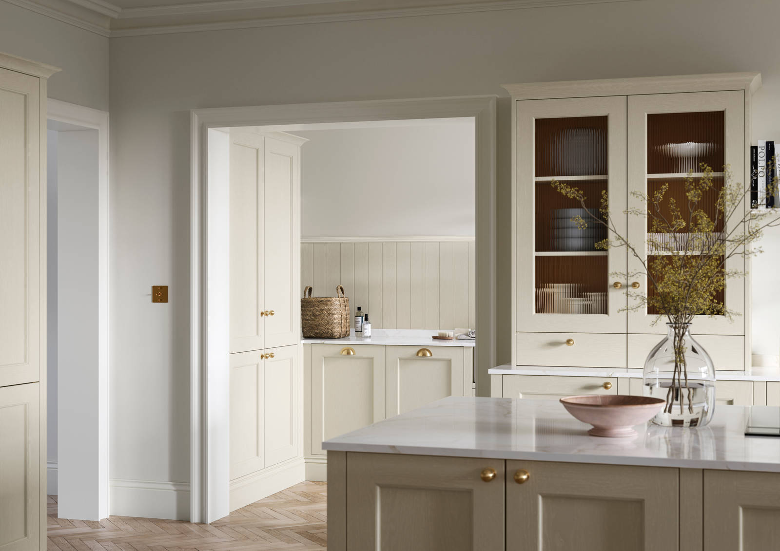 Open plan living room and Traditional Shaker-style kitchen Ludlow Parchment and view of utility room with white ceramic trough door frame, Goodrich Natural Oak herringbone engineered flooring, brass handles, brass knobs and bras tap.