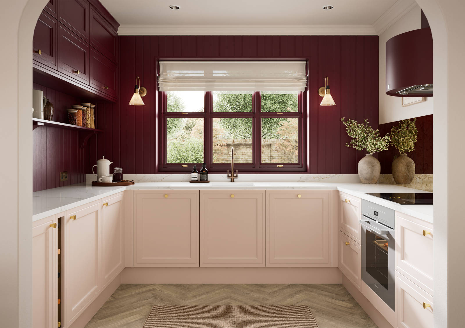 Painted wood grain Shaker style Bewdley kitchen with cabinets in light pink shade Chalk Blush, marbled worktop, brass knobs, red Morello wall-mounted cabinets with matching shelves and wall panel, built- in wine storage.
