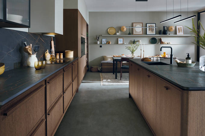 Nordic Nature kitchen from Magnet, with a kitchen island and black marbled worktops matching a splashback by the counter.
