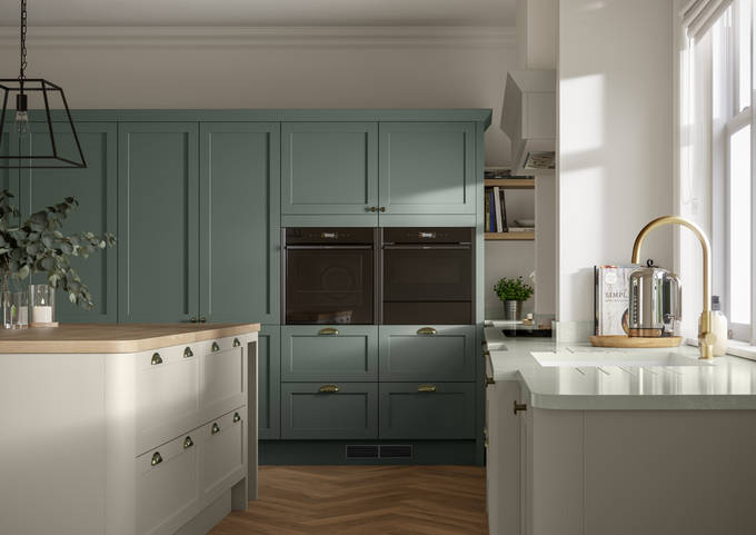 A contemporary kitchen with green and cream cabinets in Ambleside, featuring a Shaker-style design.
