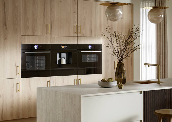 Modern Portobello kitchen cabinets in Bosco are finished with brass bar handles.