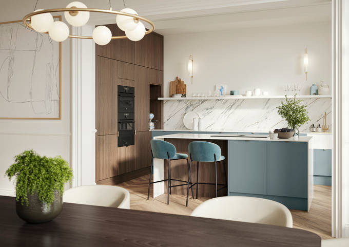 Soho Duck Blue kitchen from Magnet combined with ovens integrated into tall Nordic Nature cabinetry, white marble splashblack, paired beautifully with a bright brass tap and sink.