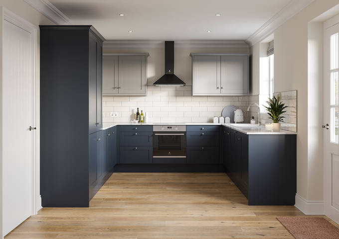 Tatton kitchen from Magnet, in U shape, with tall cabinets and matching kitchen counter cabinetry in dark blue shade Midnight paired with light grey wall cabinets over countertops, white worktop.