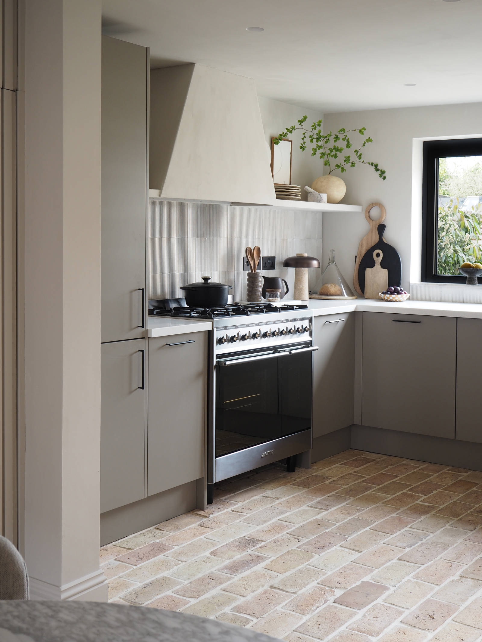 Grey kitchen in neutral earthy tones from Magnet with a range cooker and slab fronts
