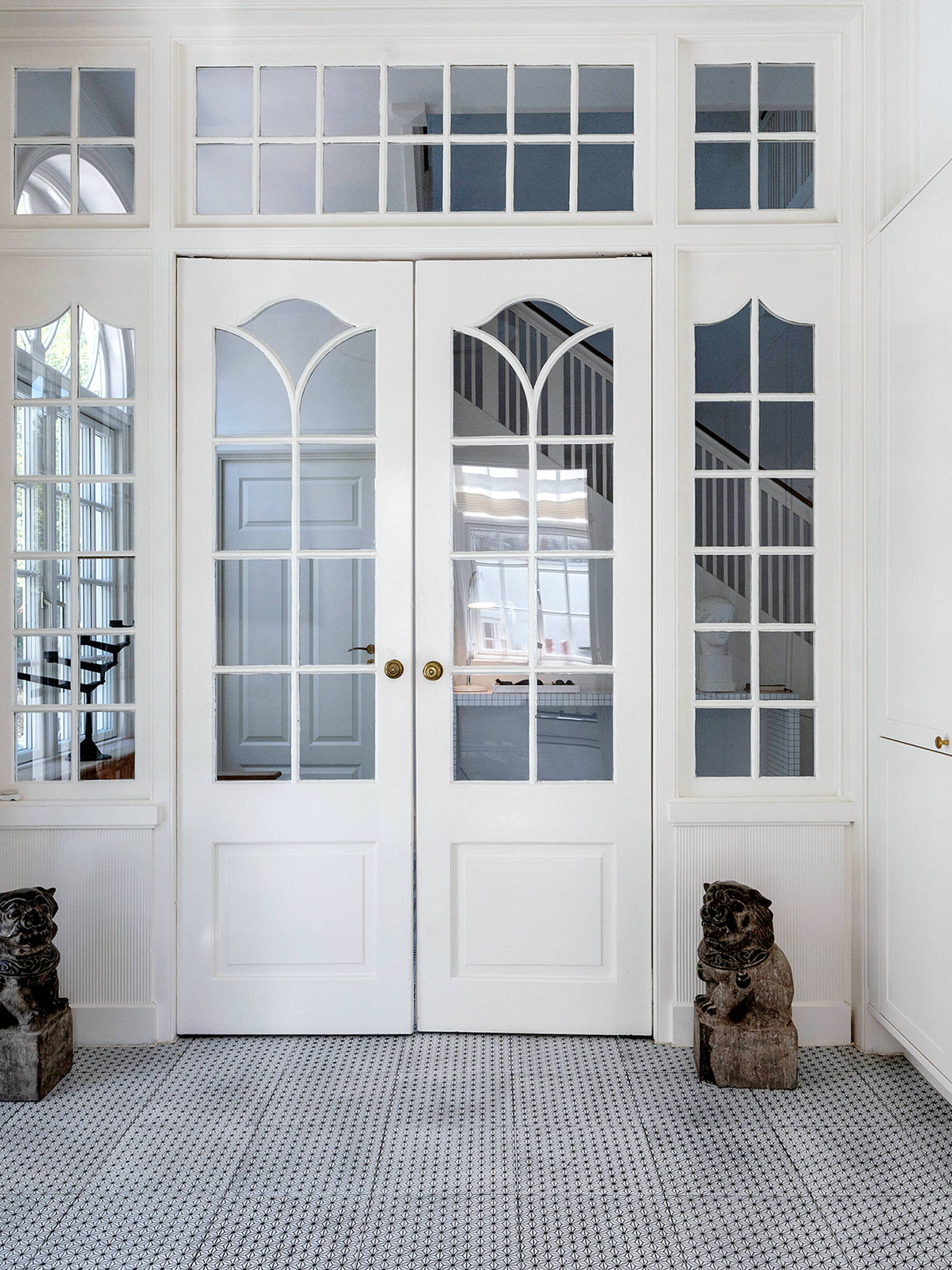 Hall in mansion with white Shaker wardrobes and handcrafted Made A Mano tiles