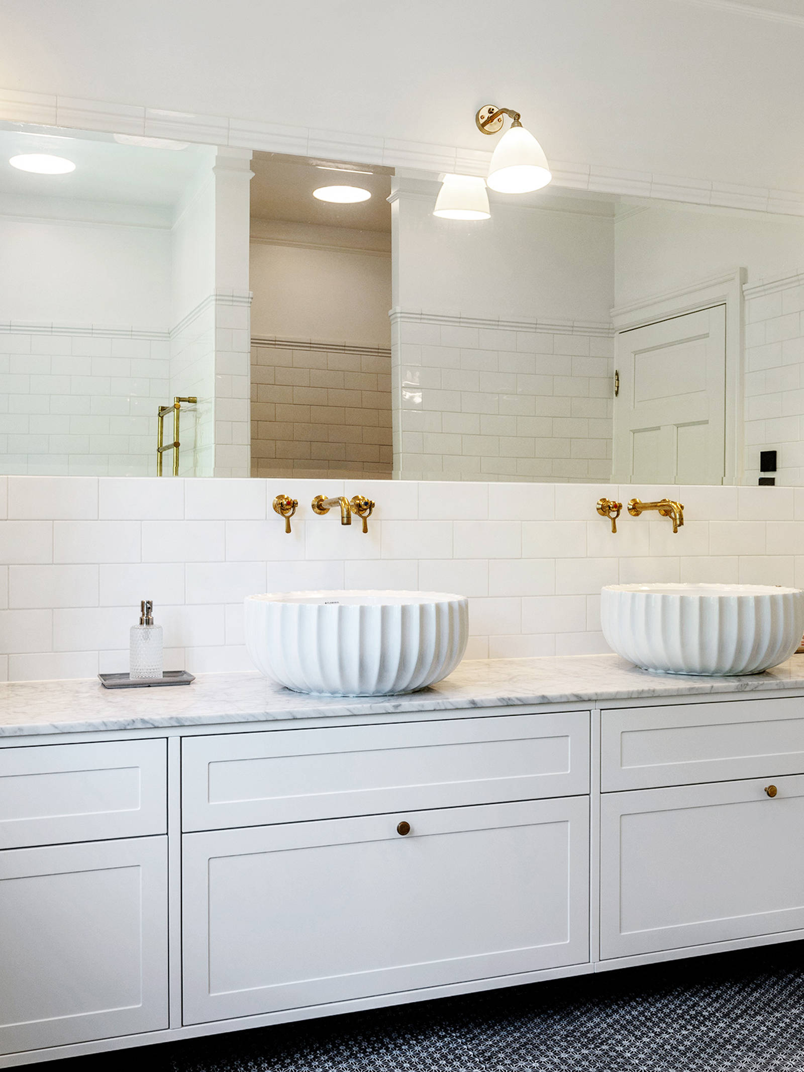 White master bathroom with subway tiles, brass fittings and handmade Made a Mano tiles