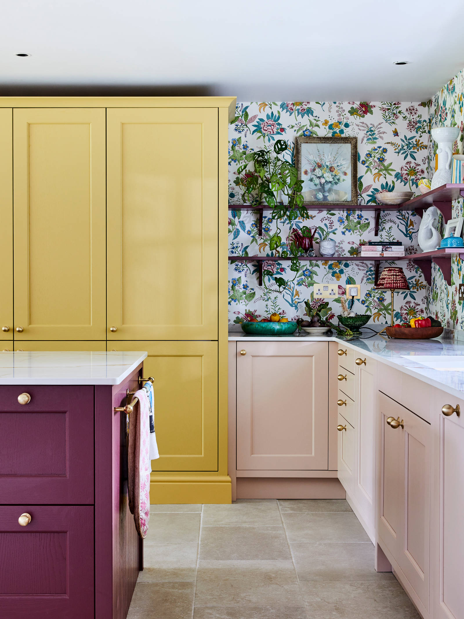 Wide image of sink, kitchen island and pantry larder. Ludlow cabinetry from Magnet in colours Burlington Red, Chalk blush and Harvest in Heritage classic with a contemporary twist.