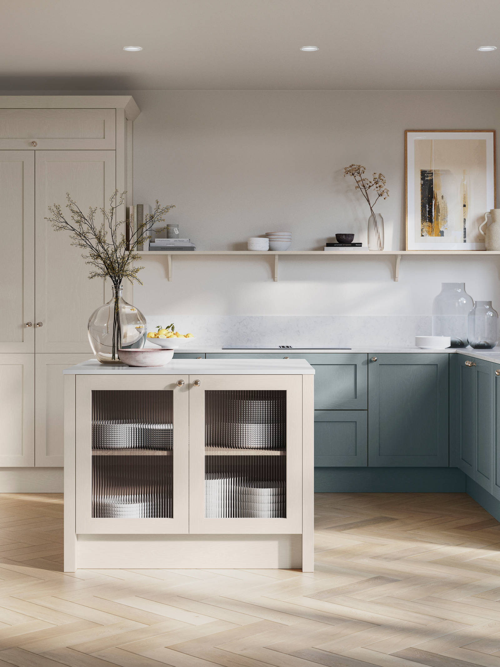 Open floorplan kitchen with small kitchen island in Wardley kitchen from Magnet in the light shade Limestone as well as blue Duck egg, decorated with flowers in glass vases and earth toned ceramics.