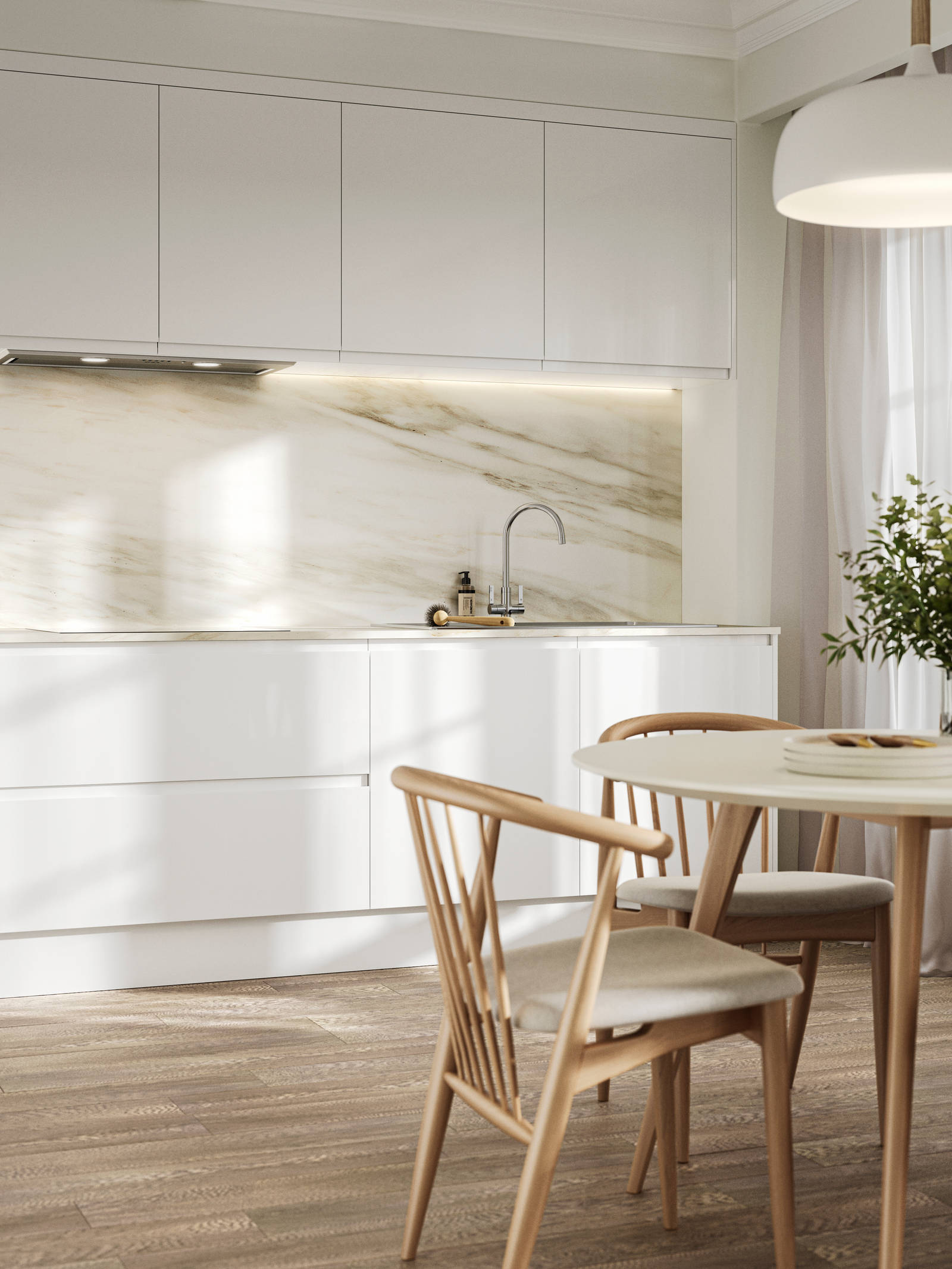 Handleless white gloss Luna kitchen from Magnet, a round wooden kitchen table with matching chairs in foreground