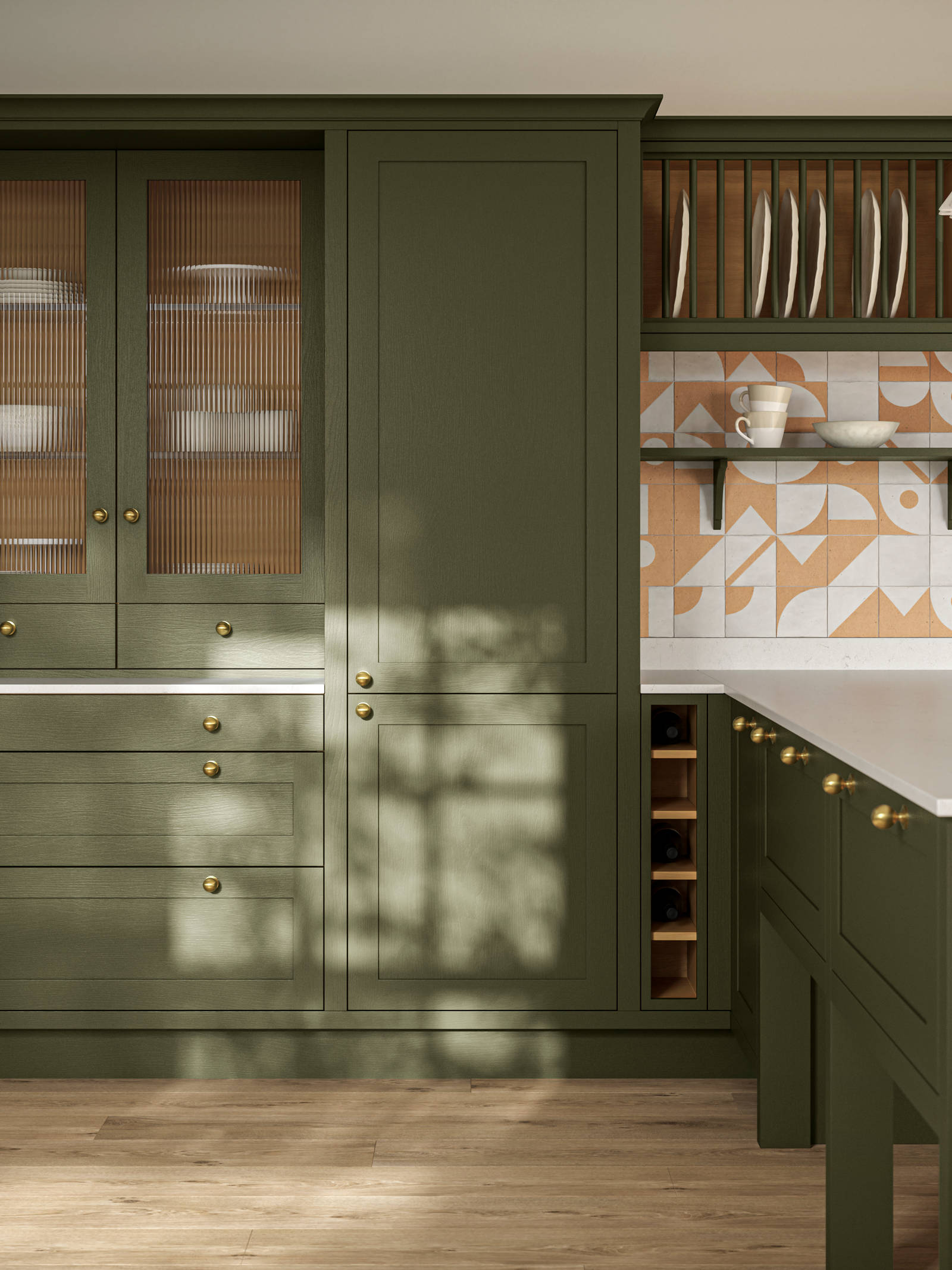 Premium Shaker kitchen Wardley Tailored green with kitchen island, traditional detailing, brass accessories, white worktop and Classic Flint Grey oiled oak engineered wood flooring.