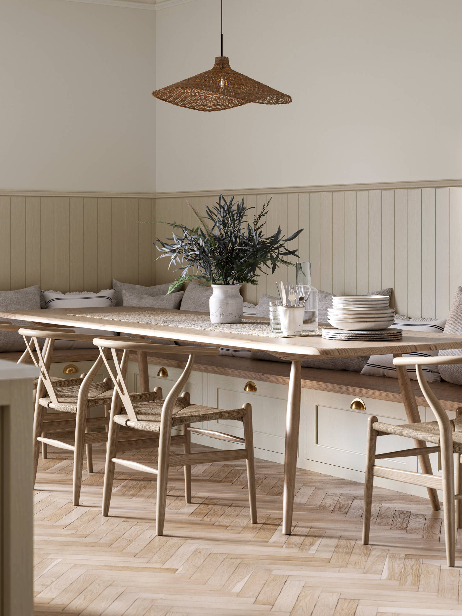 Traditional Shaker-style Ludlow Parchment bench cabinets with tactile woodgrain, a kitchen island and matching wall panel, a long wood diningroom table with matching wood chairs and ceramics set out on the table.