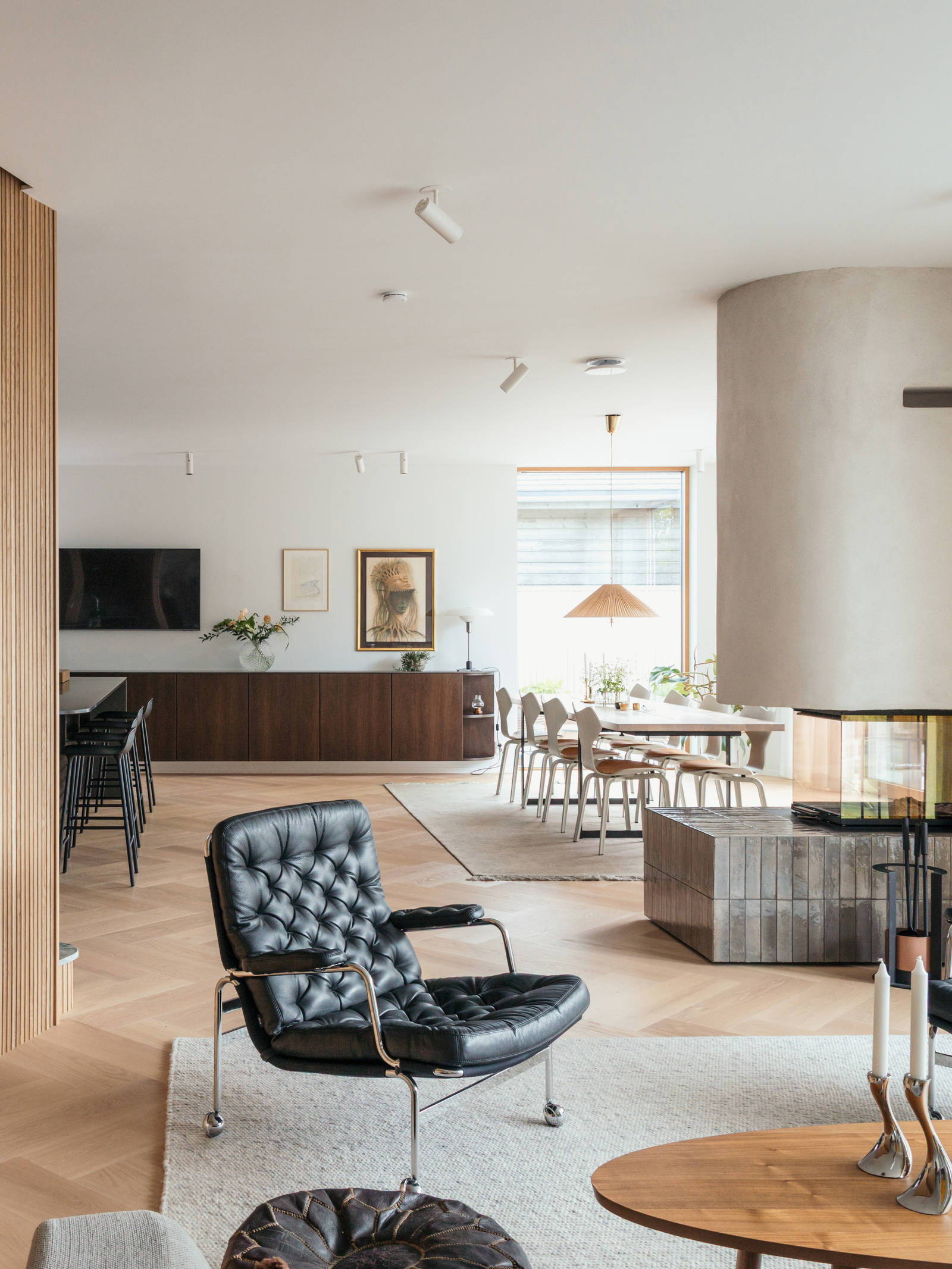 The house's large living area includes a kitchen, dining room, and sitting room.