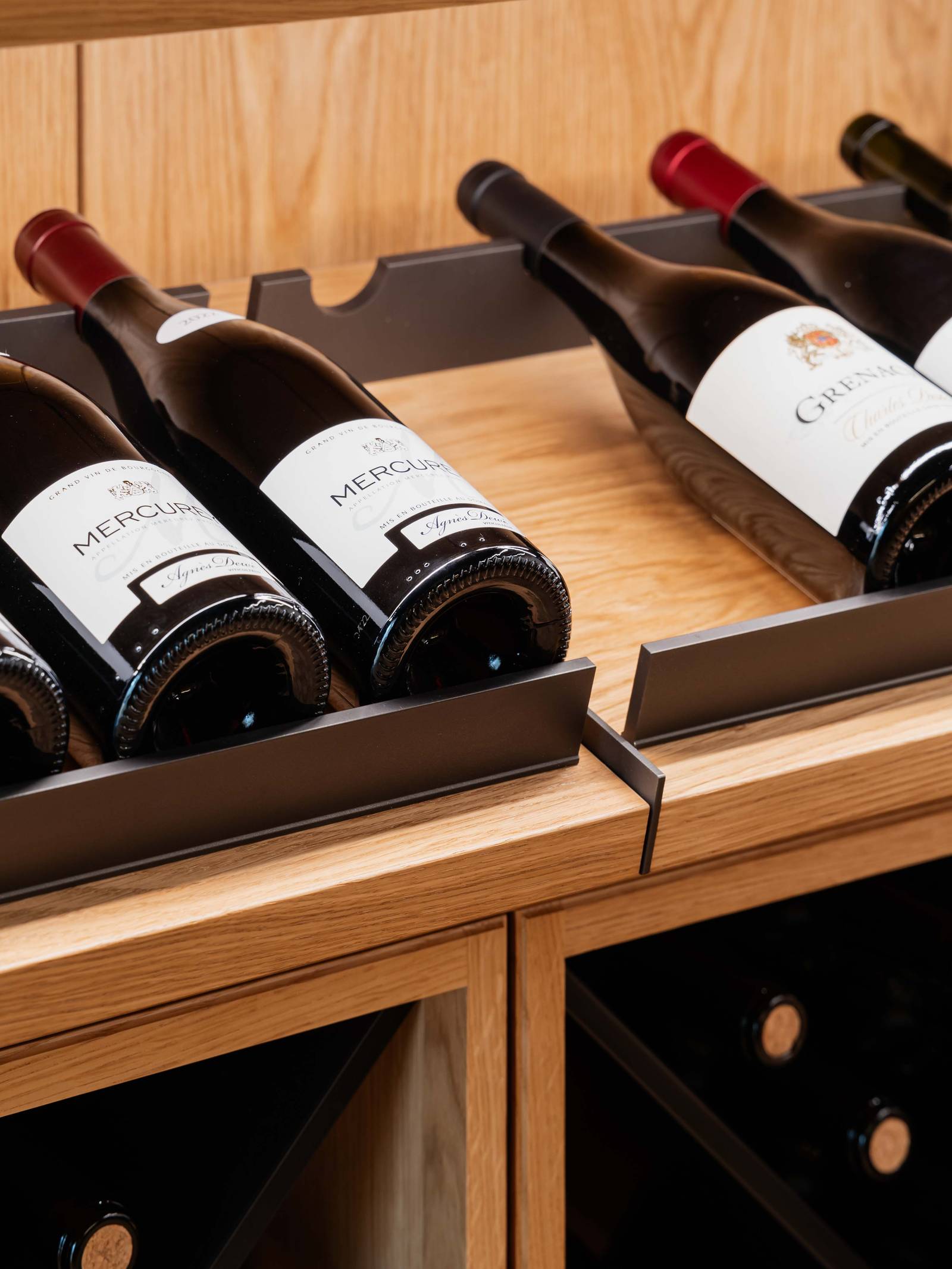 Vinkælder med skråtstillede hylder til flasker on display.