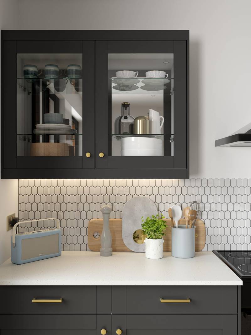 Close-up of framed glass front display cabinets Tatton Midnight kitchen from Magnet, a contemporary dark blue narrow frame shaker door.