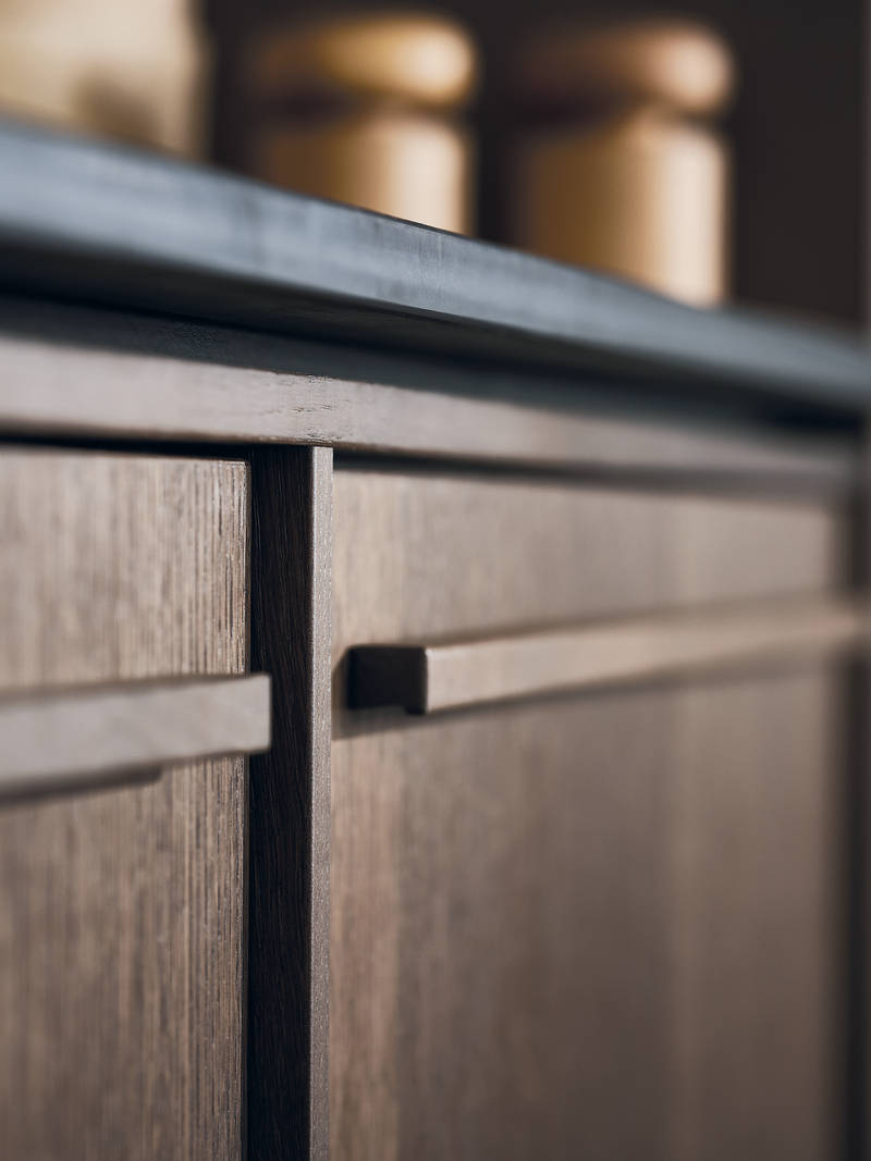 Close-up of Nordic Nature cabinets with wood fronts and handles.